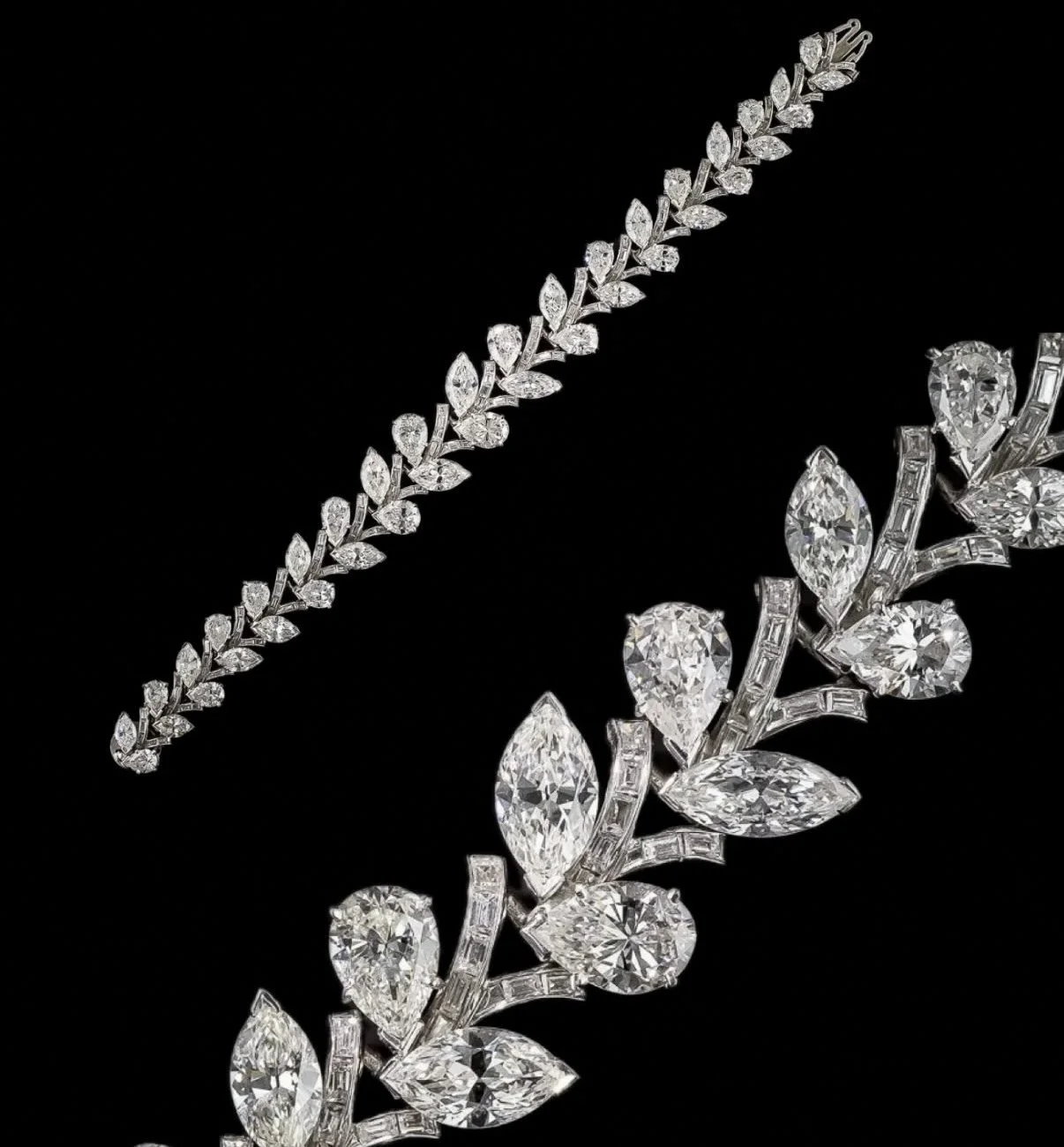 A close-up of a diamond necklace and brooch against a black background.