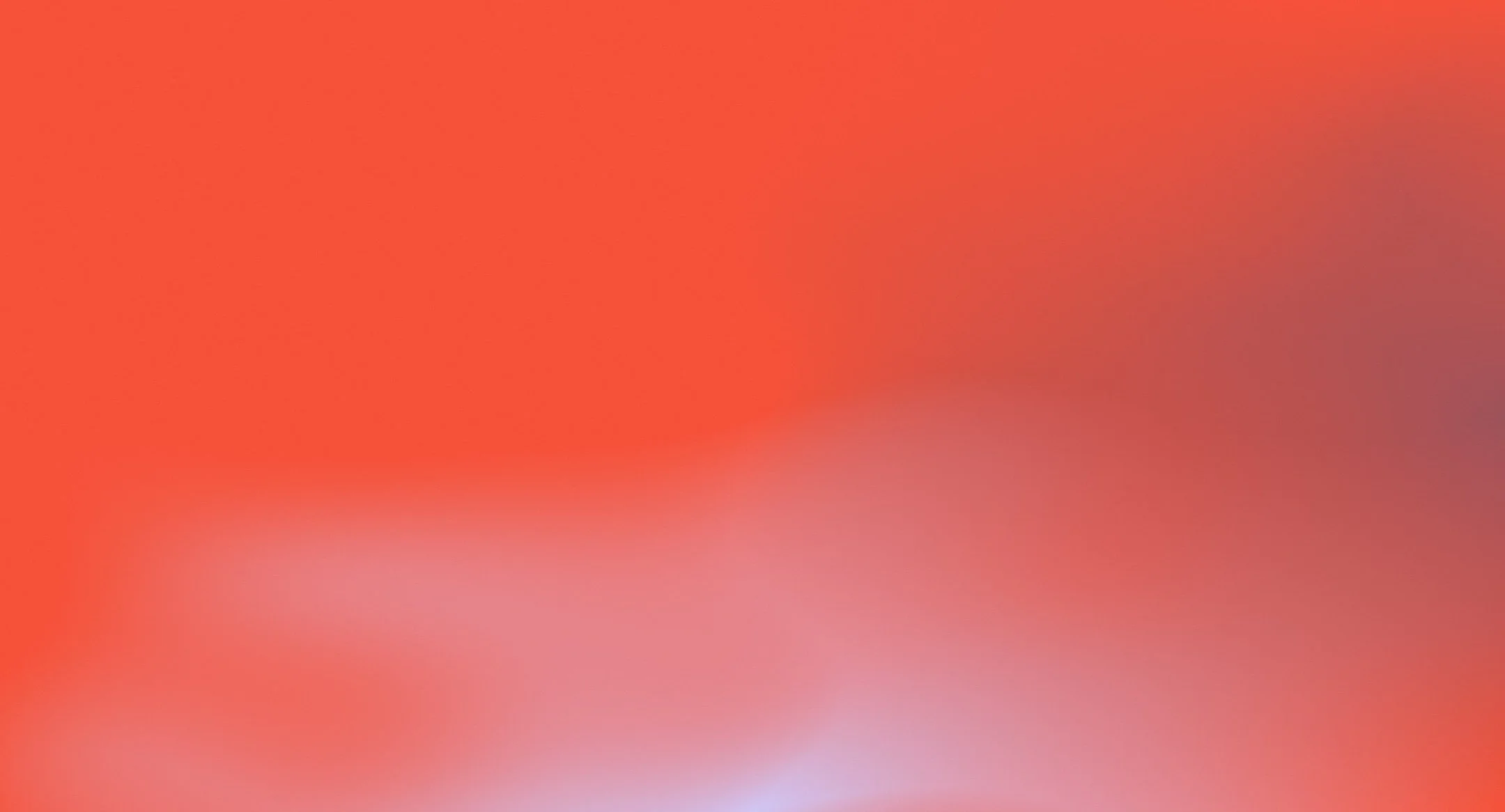 A blurred gradient of warm colors, including red, orange, pink, and purple.