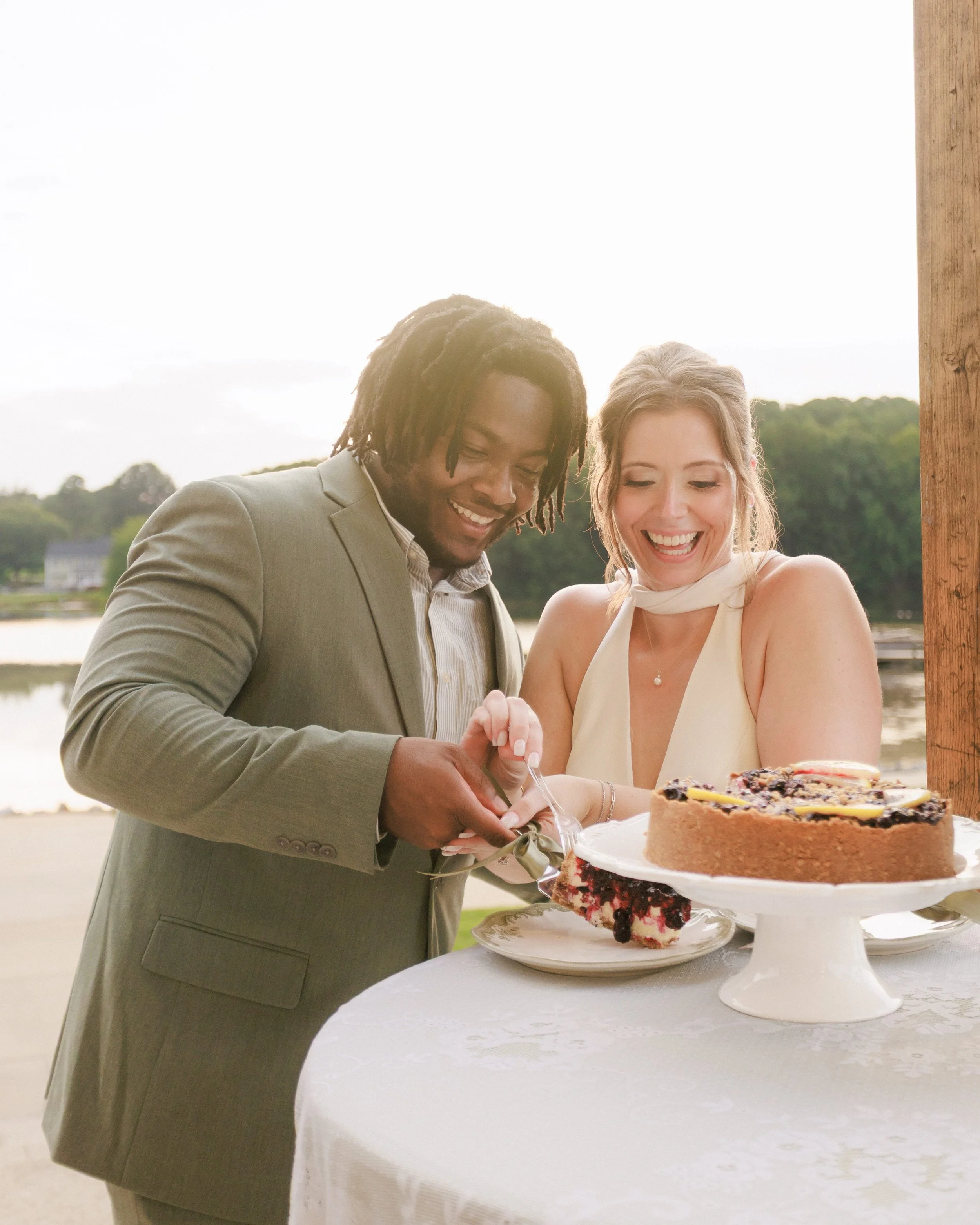 bride and groom cutting a slice of cheesecake