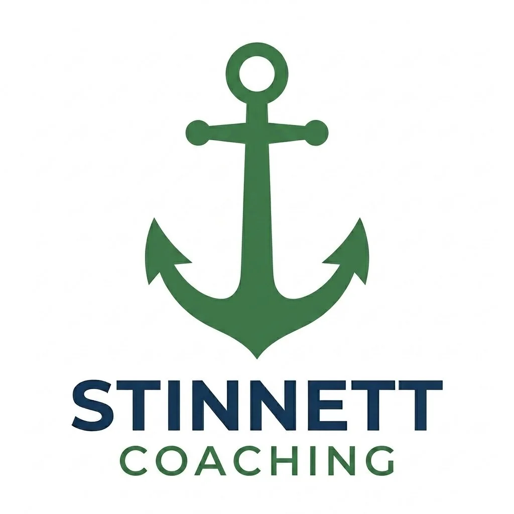 Green anchor symbol above the text "Stinnett Coaching" with the words "Stinnett" in navy blue and "Coaching" in green.