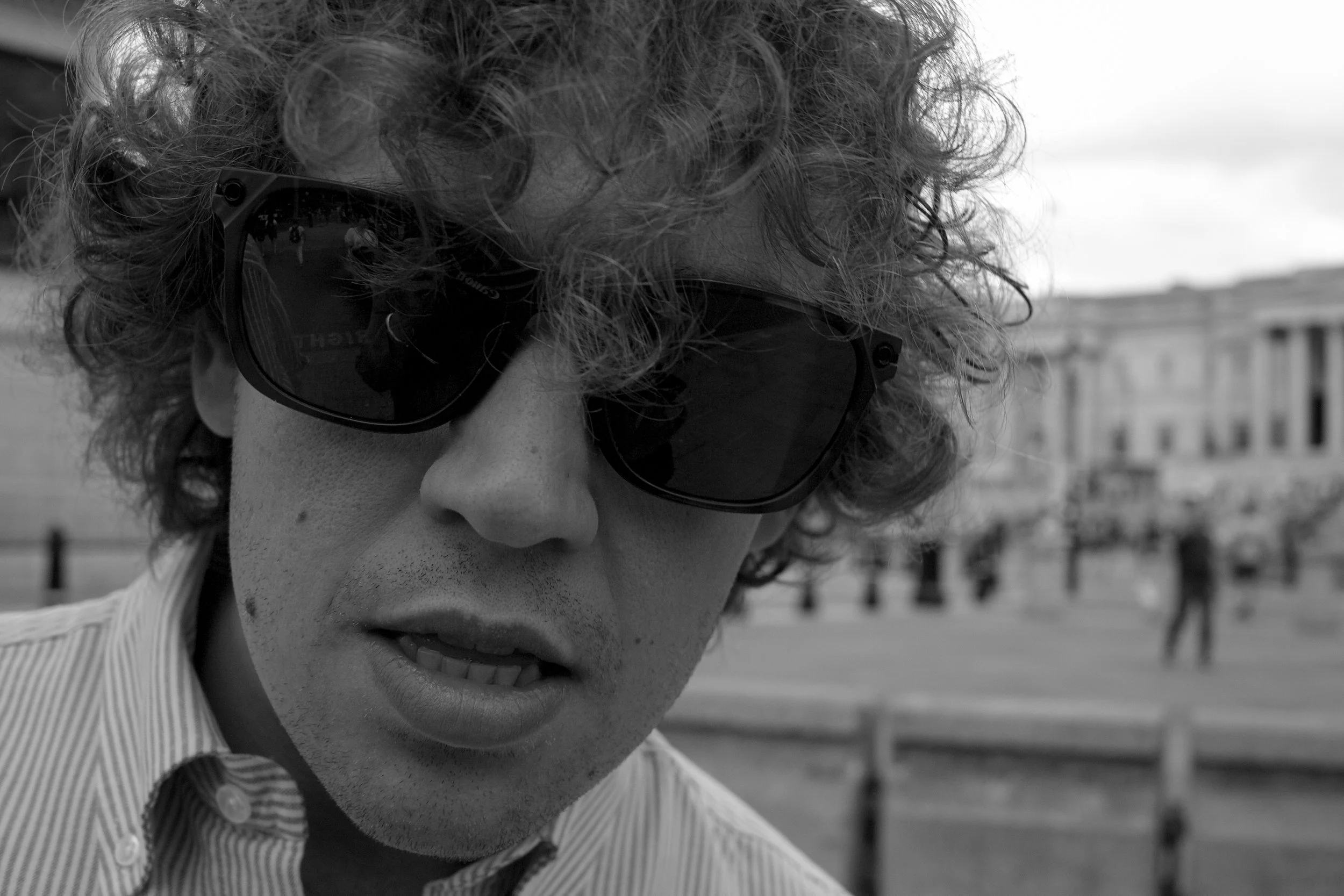 Close-up black-and-white portrait of a music artist in London, photographed with a raw editorial feel and relaxed, unforced expression.