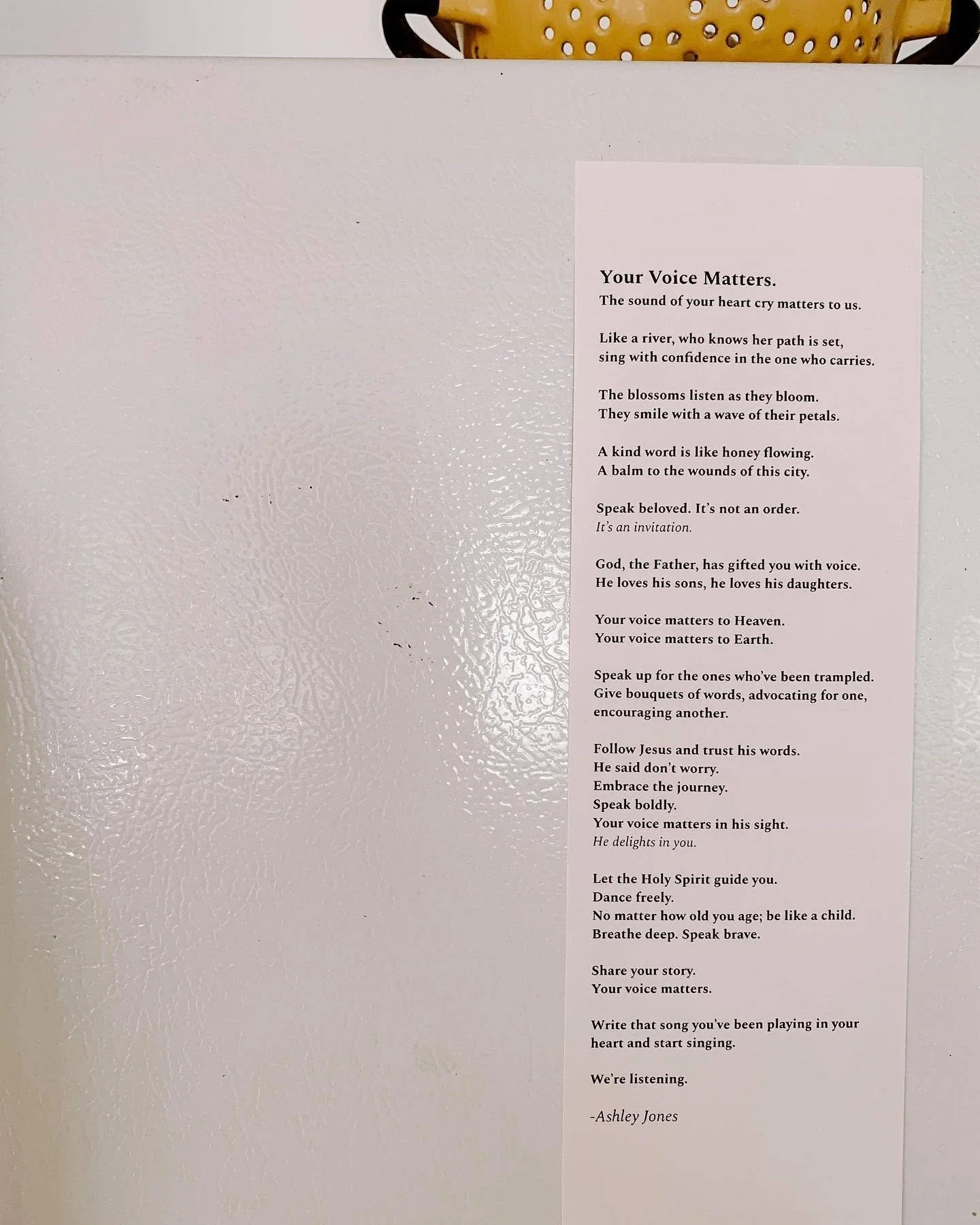 A printed poem titled "Your Voice Matters" posted on a white textured wall. A yellow basket with holes is visible at the top of the image.
