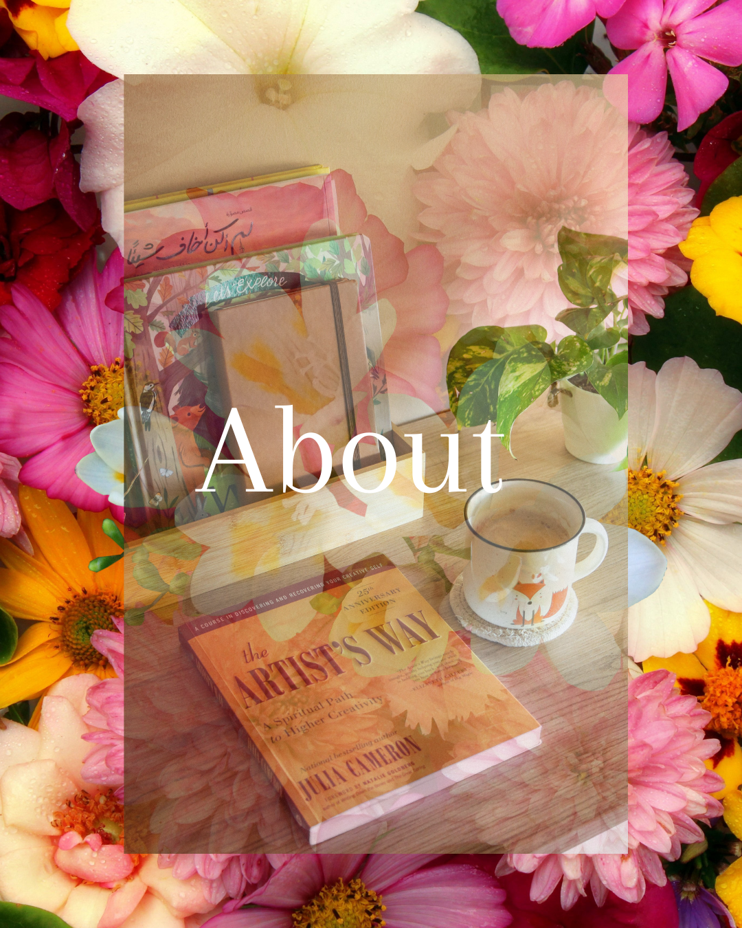 A table with a book titled 'The Artist's Way,' a mug with a fox illustration, a plant in a white pot, and decorative papers or small books, surrounded by a colorful bouquet of flowers.