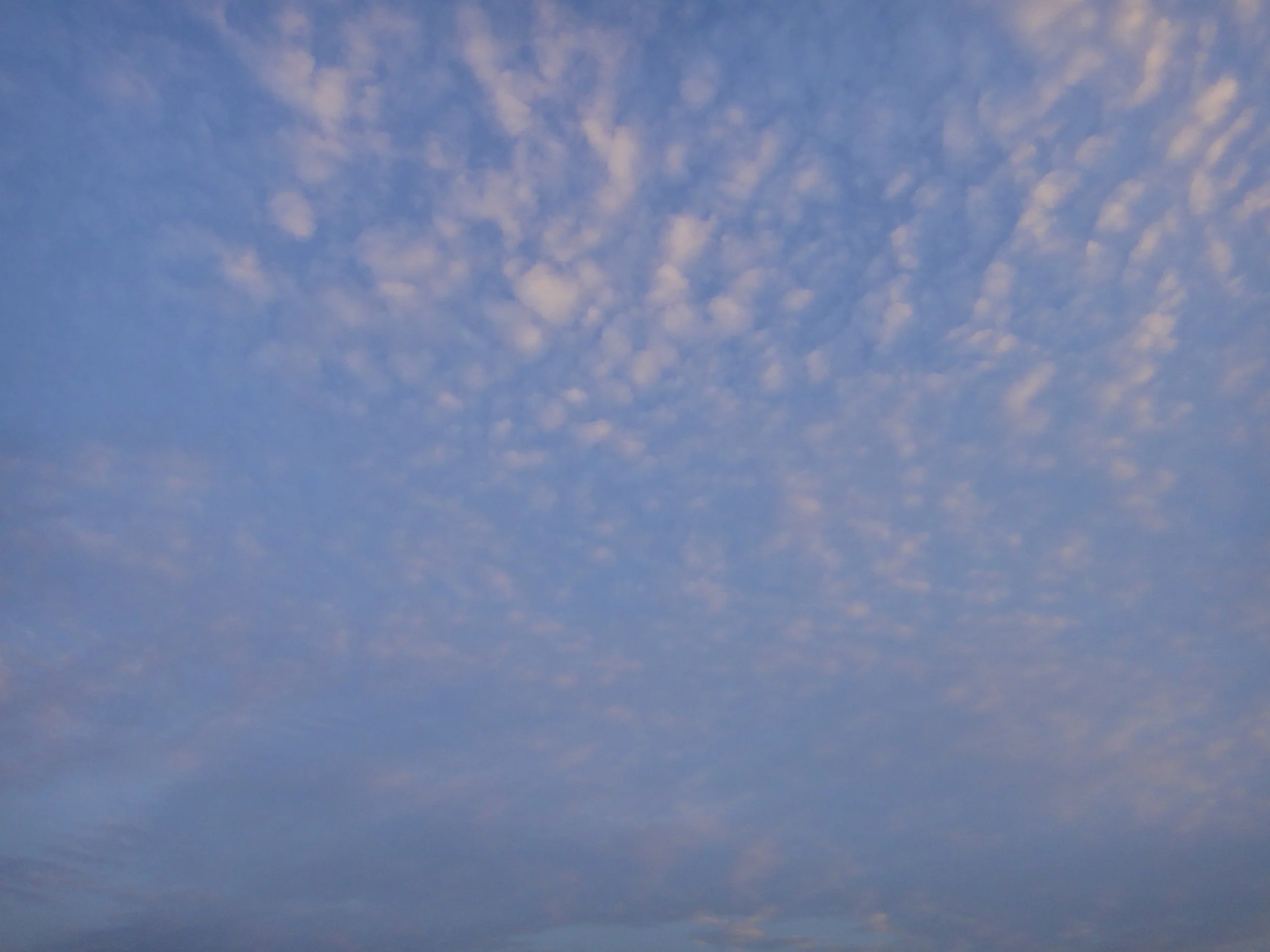 Clear blue sky with scattered white clouds.