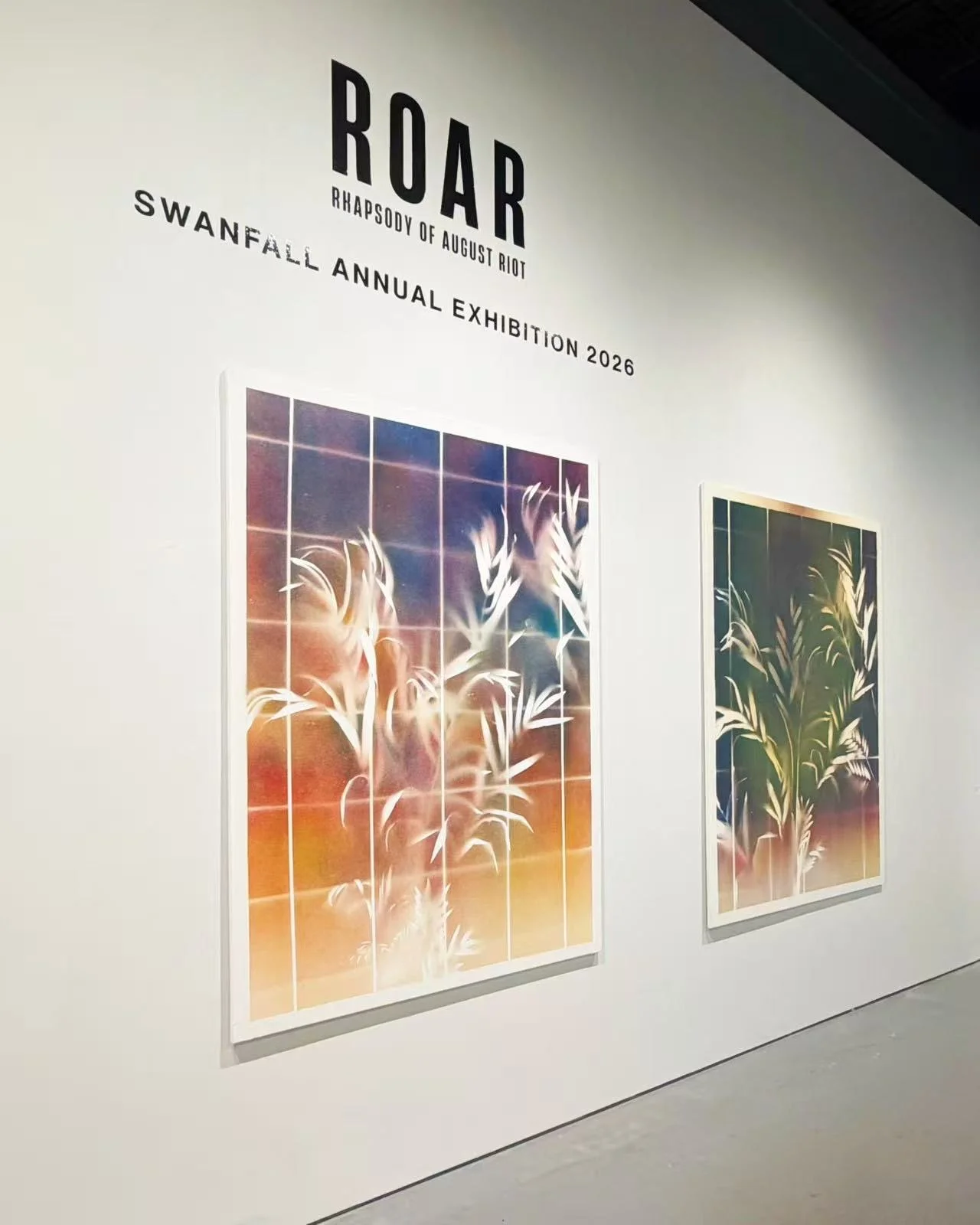 Gallery wall with two colorful abstract nature paintings of plants, titled 'ROAR Rhapsody of August Riot' for Swanfall Annual Exhibition 2026.