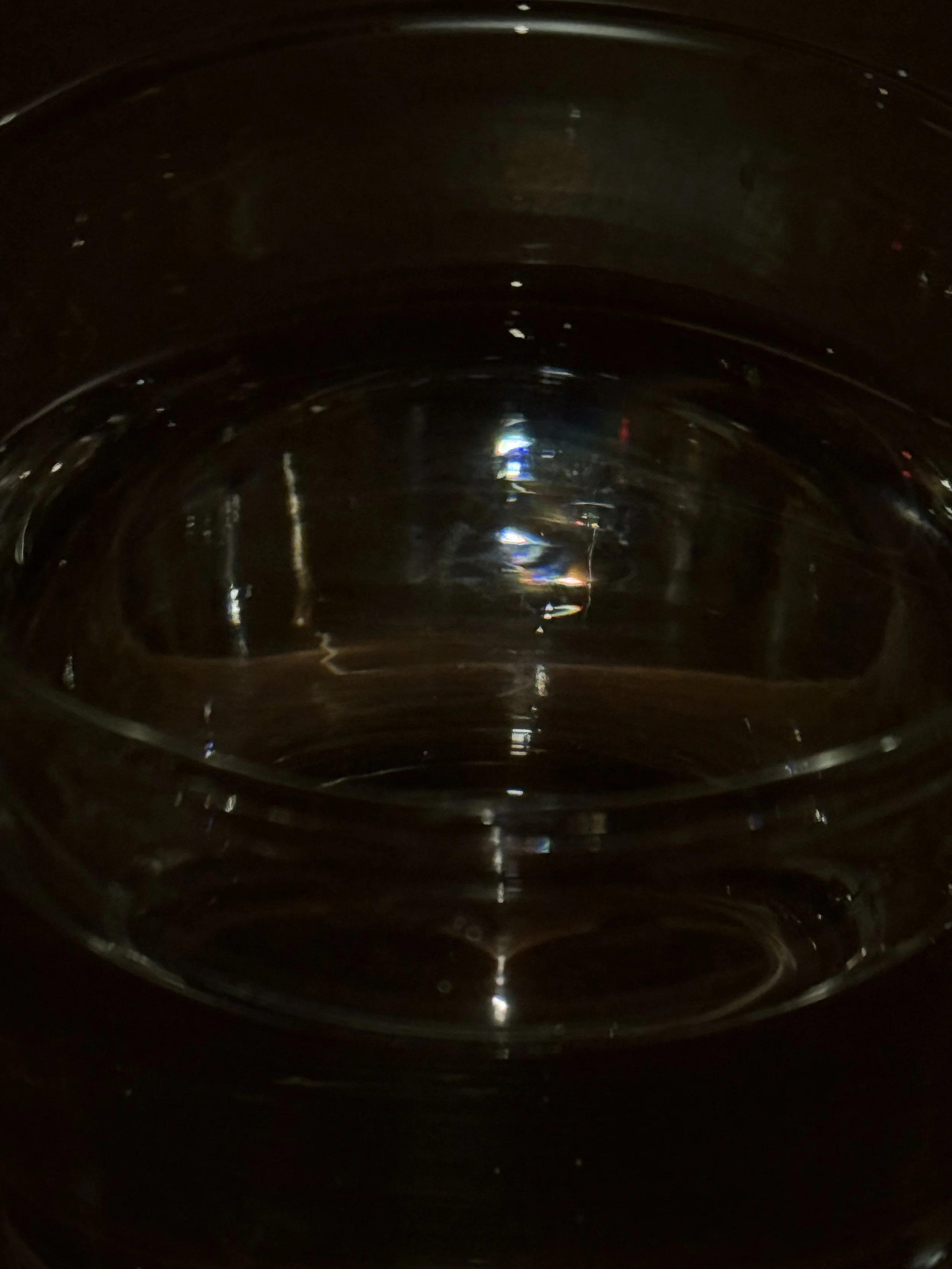 The photo shows the inside of a dark metallic container, possibly a metallic bowl or pot, with a shiny reflective surface.