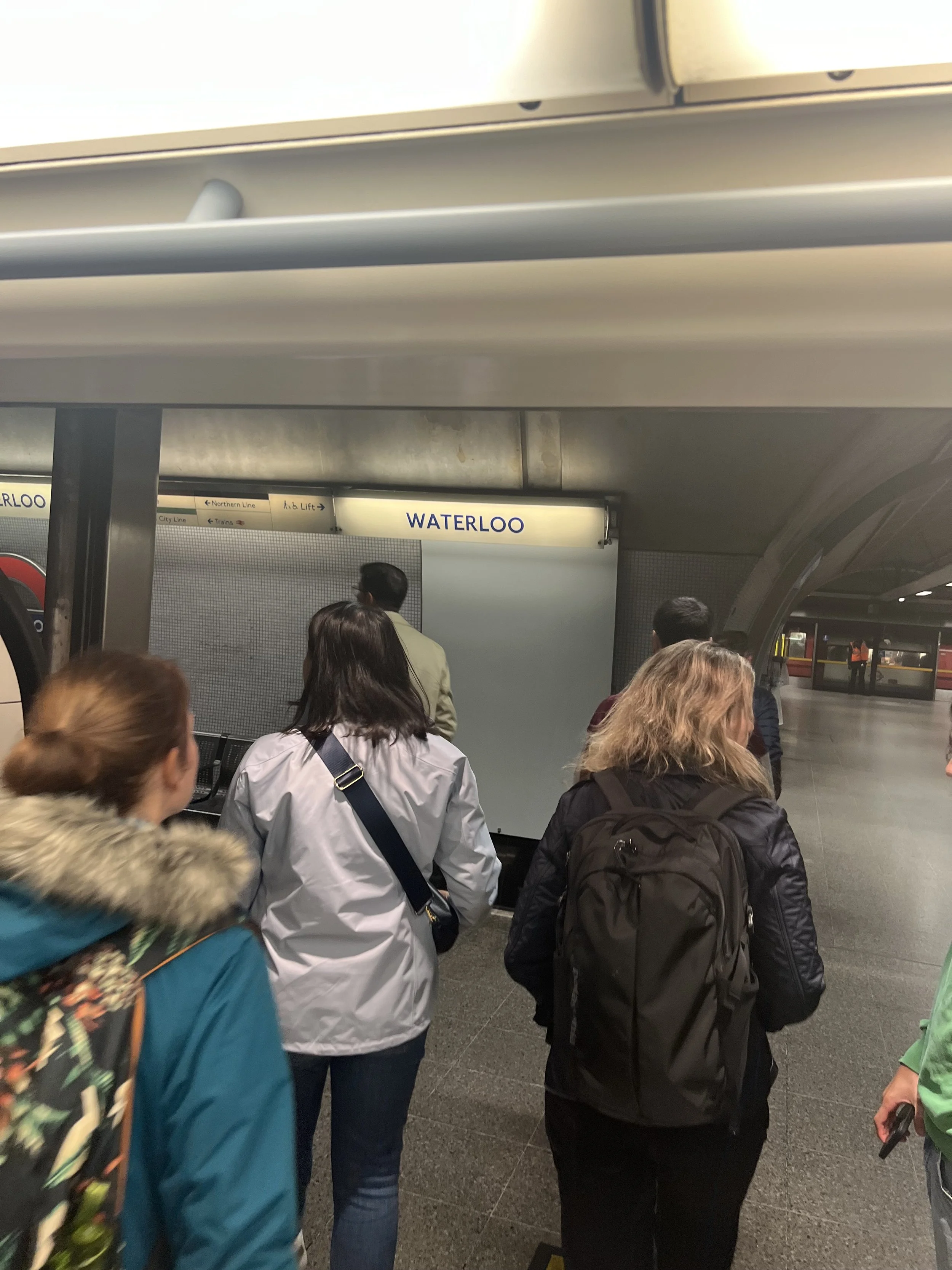 People waiting in line at Waterloo subway station.