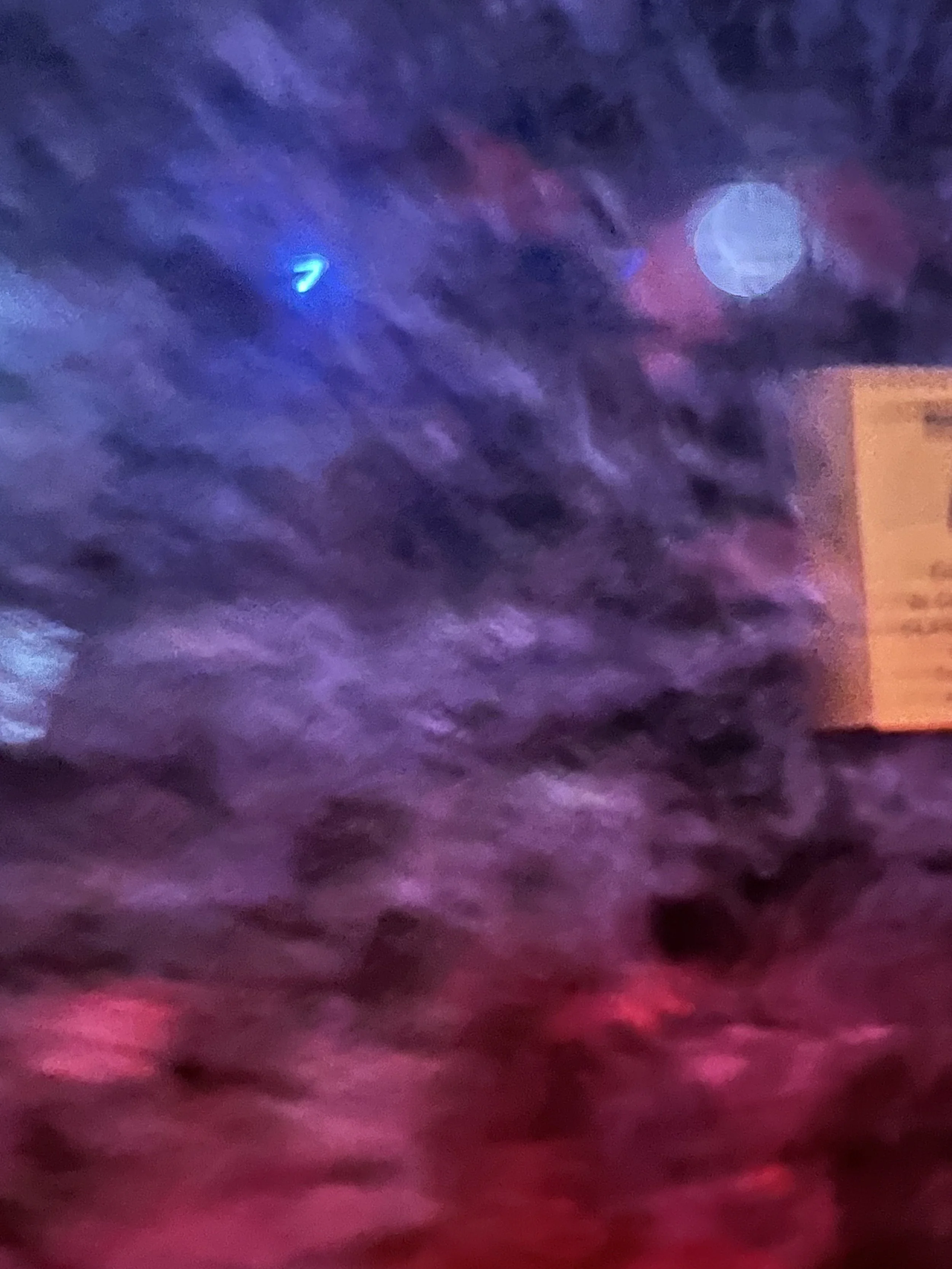 Blurred abstract image with shades of blue, purple, pink, and red.