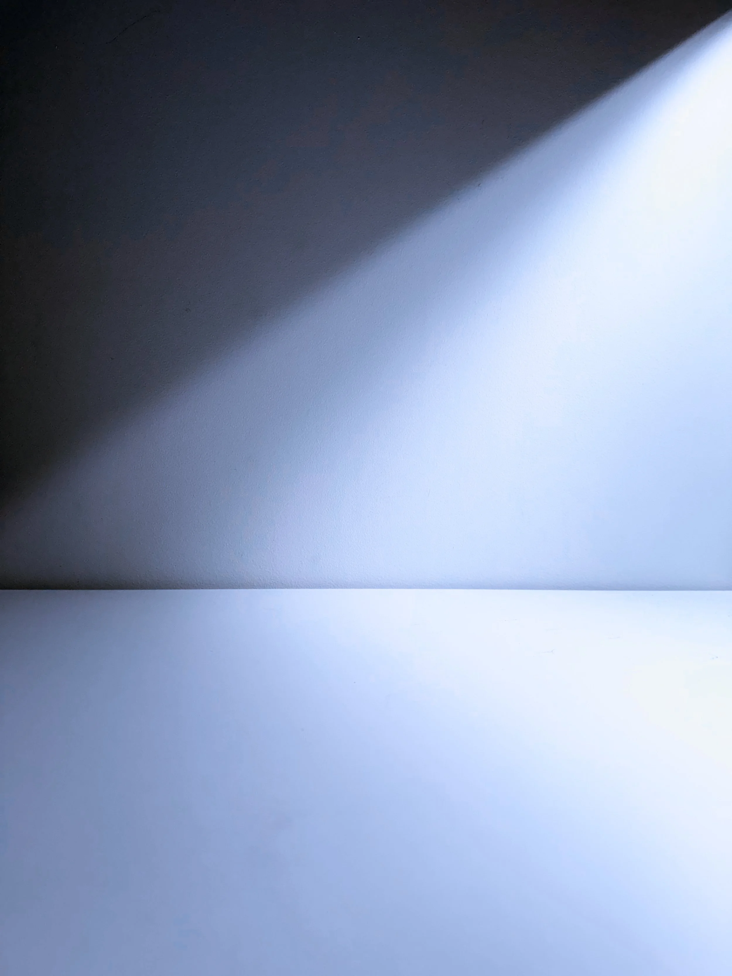 Close-up of a laptop with light and shadow on the screen