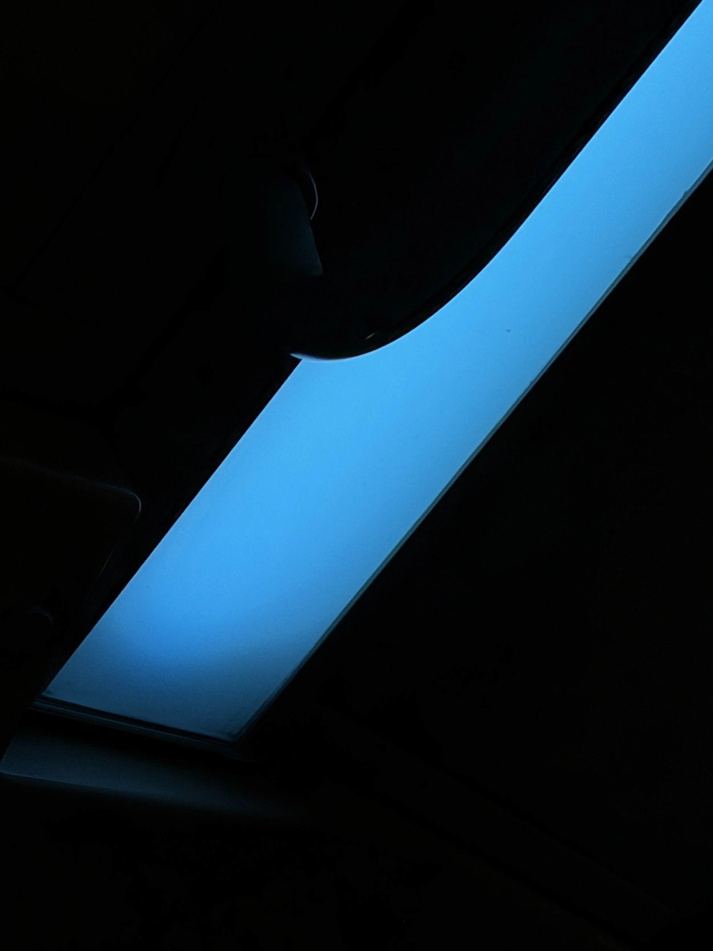 A computer screen displaying a bright blue text box in a dark environment.
