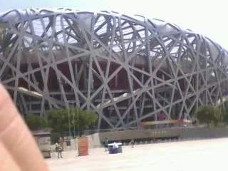 Exterior of a large stadium with a distinctive lattice-like metal framework