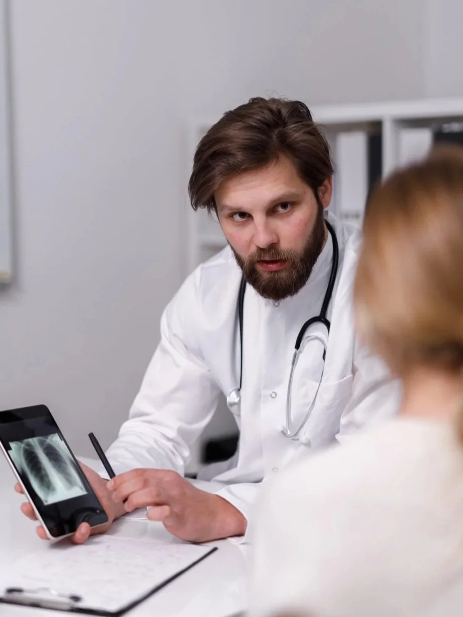 Doctor explaining x-ray results on a tablet to a patient