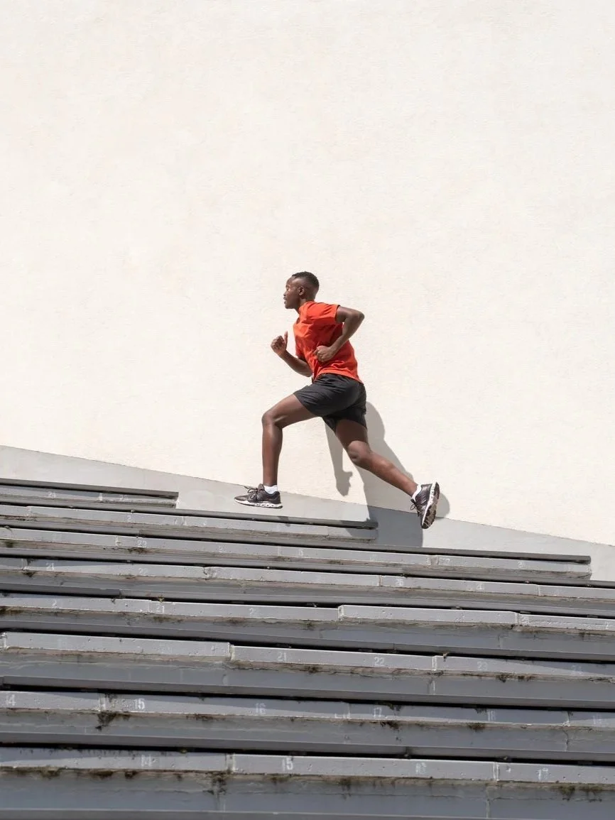 Man running up a set of concrete stairs