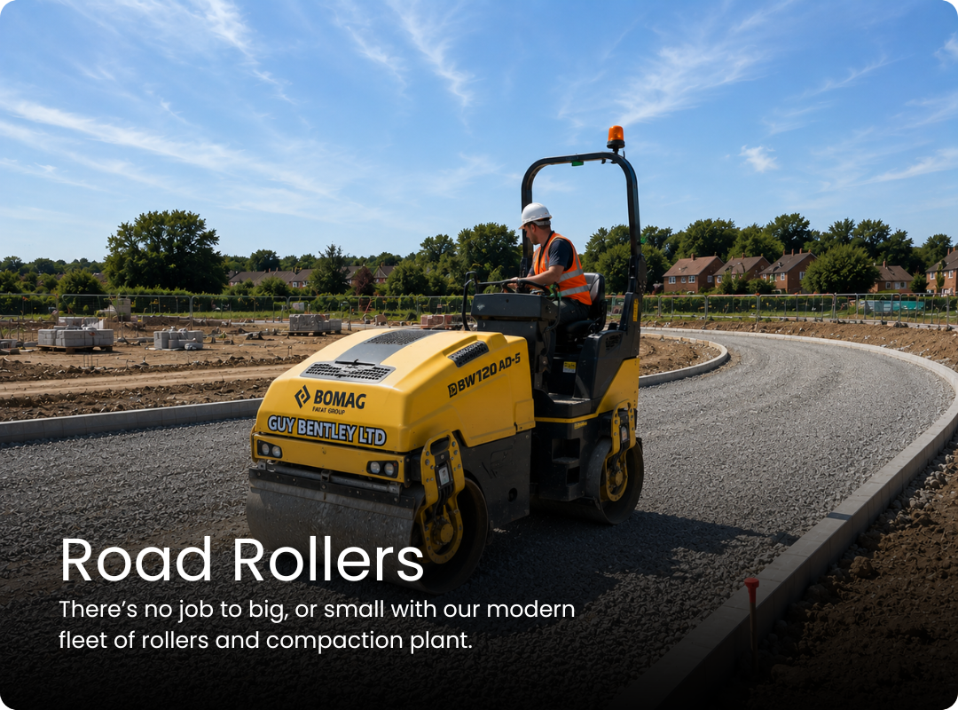 BOMAG BW120AD-5 road roller compacting gravel at a residential construction site.