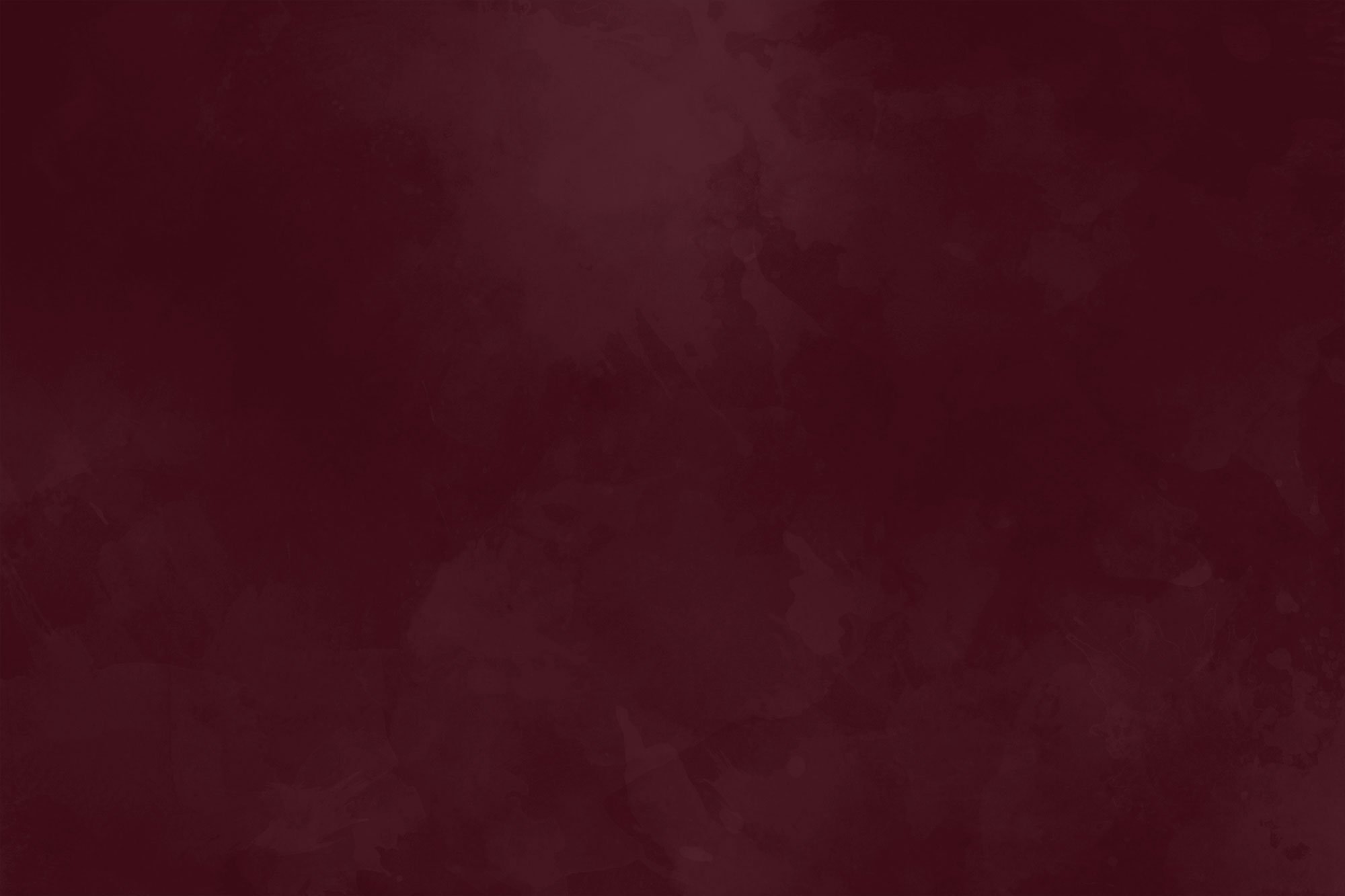 A blurry, dark red abstract background with no distinguishable objects or figures.