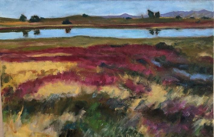 A landscape painting depicting a field of colorful flowers, a body of water, and distant mountains under a blue sky.