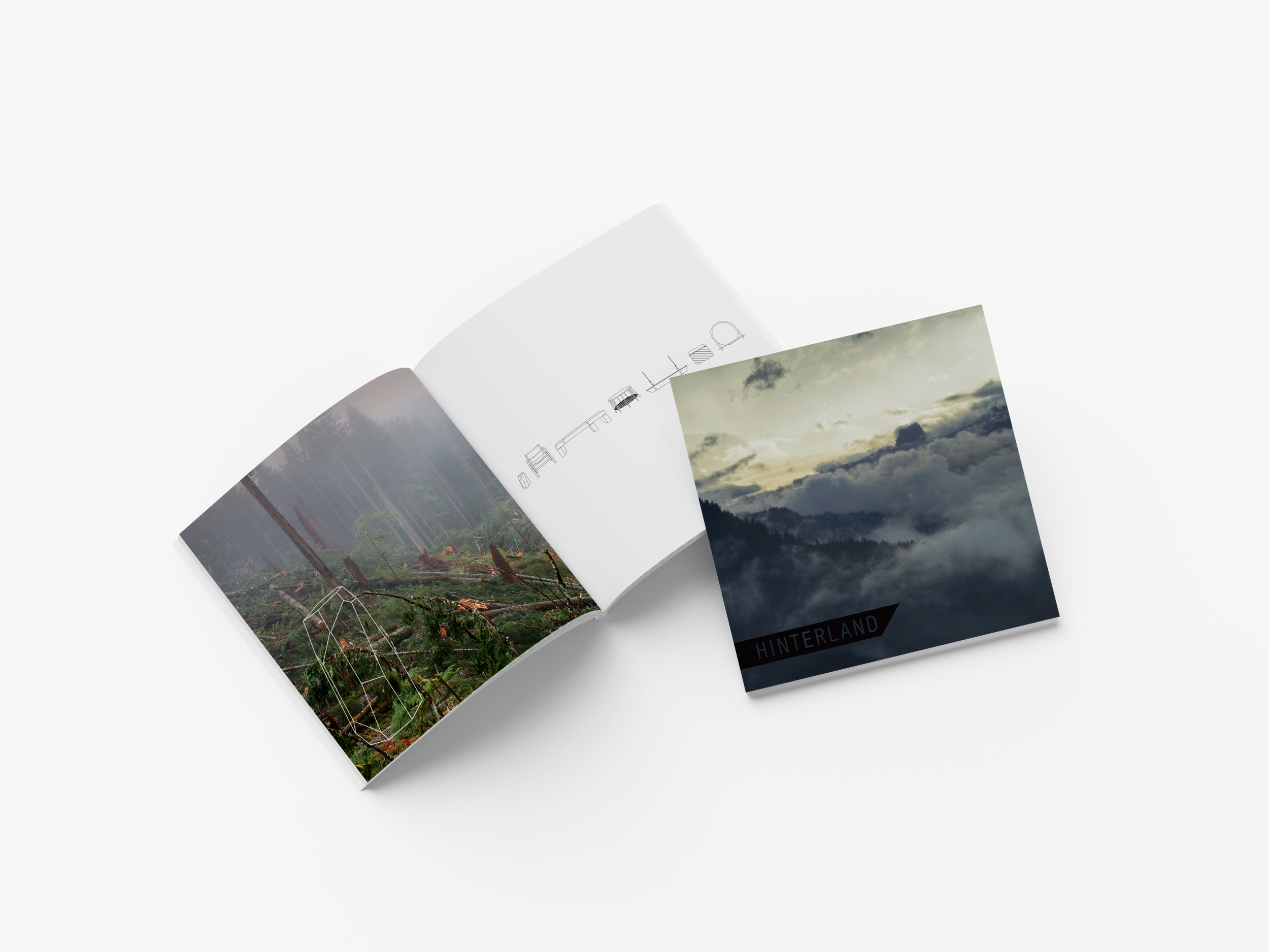 Open magazine with images of a forest, drawings of furniture pieces, and a cloudy sky.