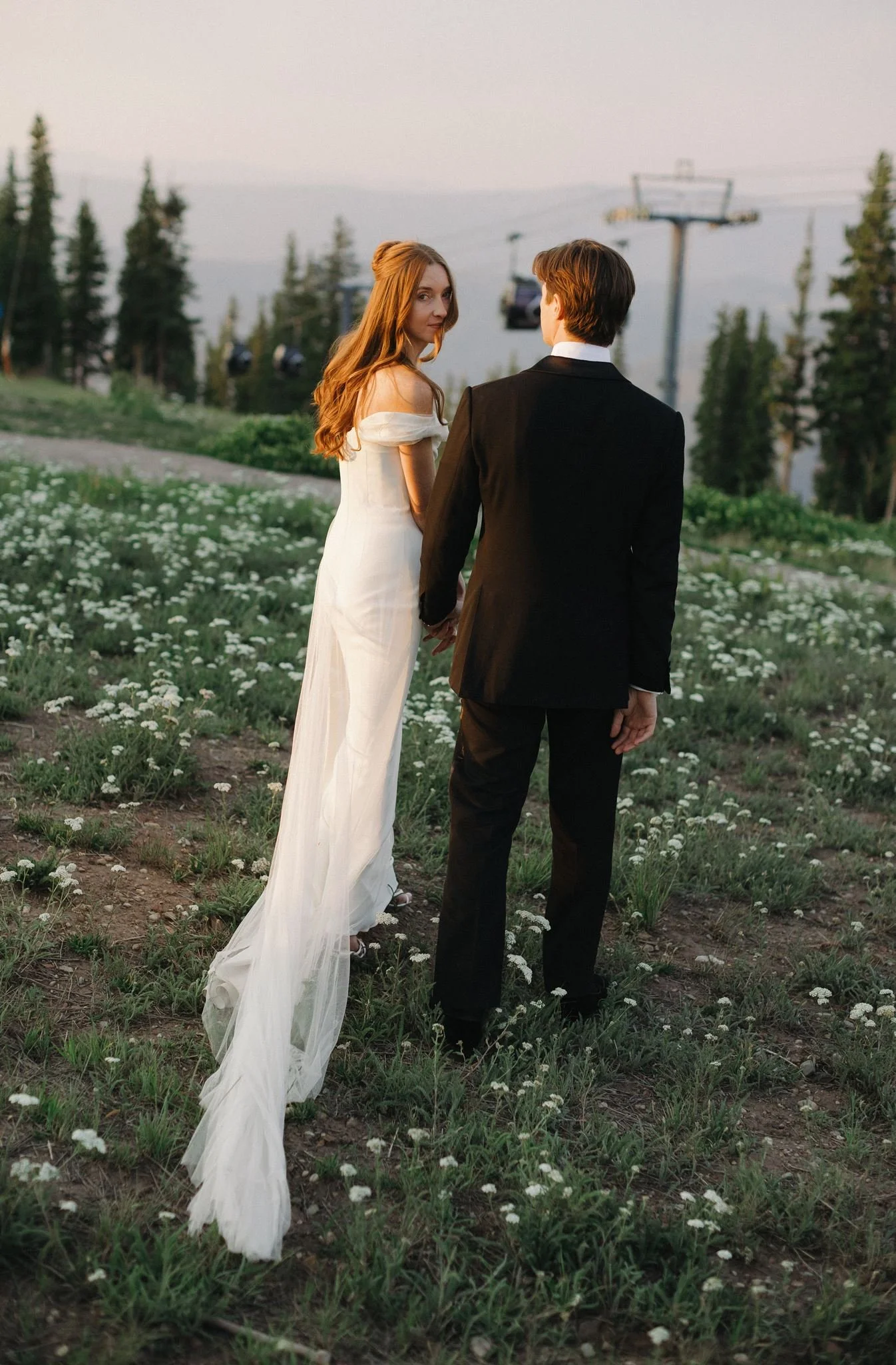 Natural bridal portraits of a bride and groom in front of the Aspen gondola at the Little Nell. Bride is wearing Danielle Frankel.