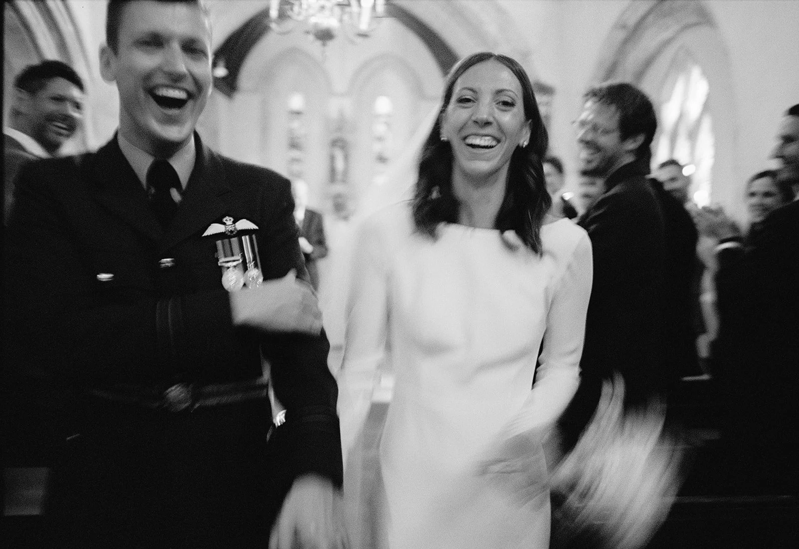 A bride and groom exit their ceremony in the Cotswolds, on film.