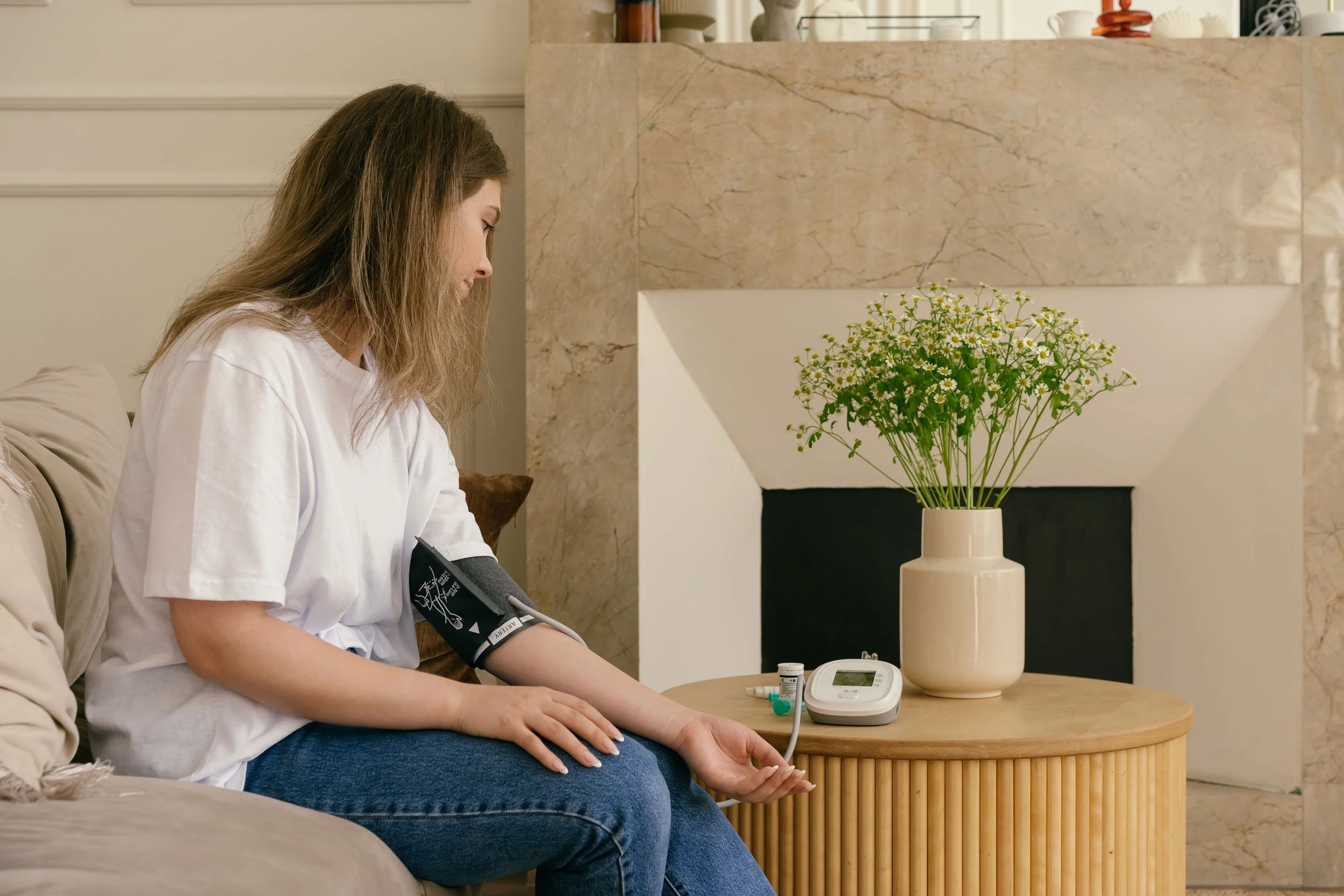 Woman checking blood pressure at home