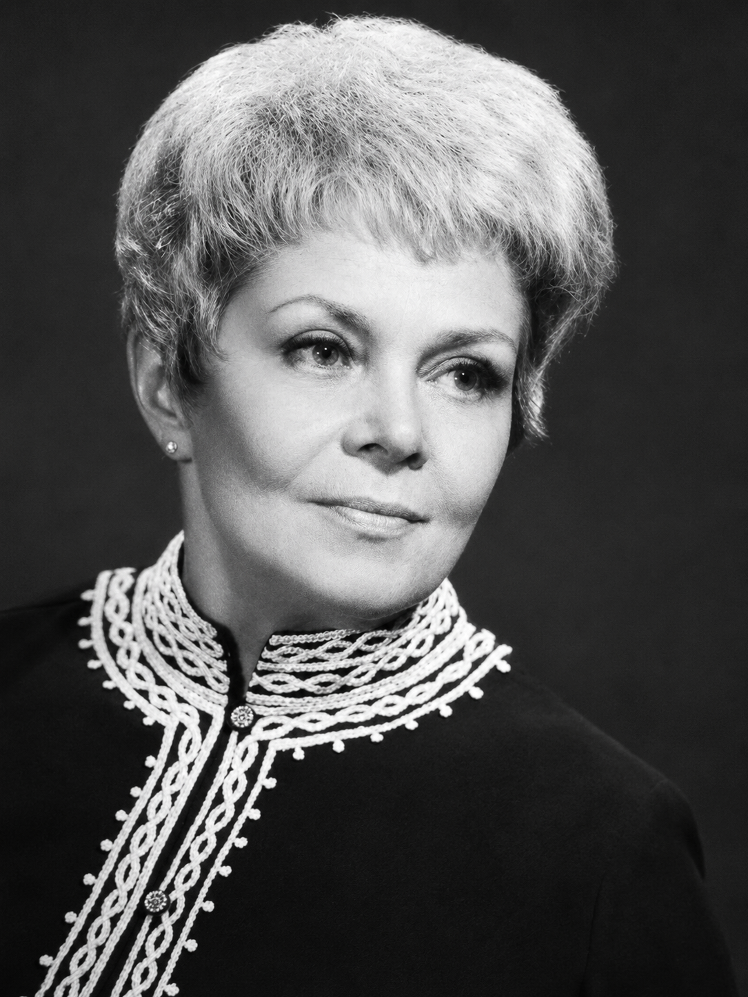 Professional black-and-white portrait of Ethel Barrett, author and storyteller known as “The Story Lady,” wearing a high-collared embroidered jacket.