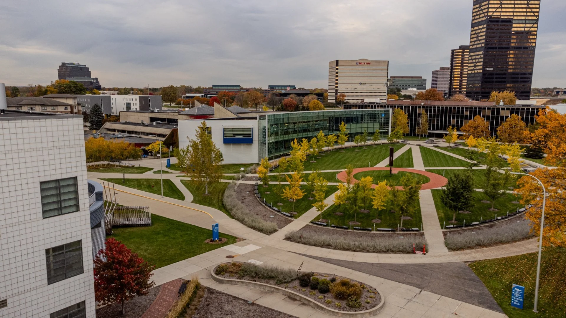 A university campus with walkways, trees with autumn leaves, and modern buildings in the background. - Taken by Dillon Morby of D Morby Media, a local photographer working in South East Michigan