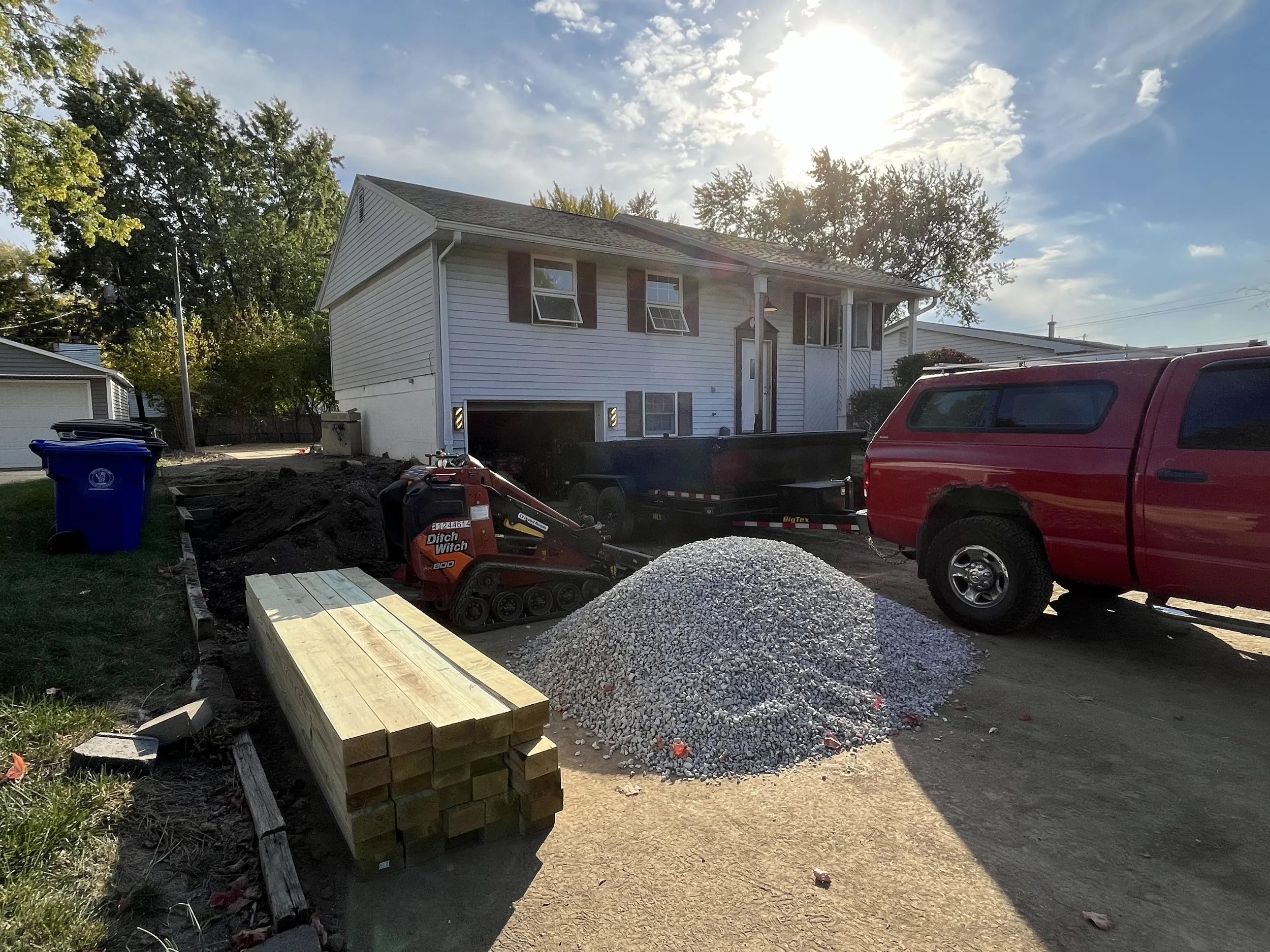 Bringing in gravel and new lumber for the front retaining wall.