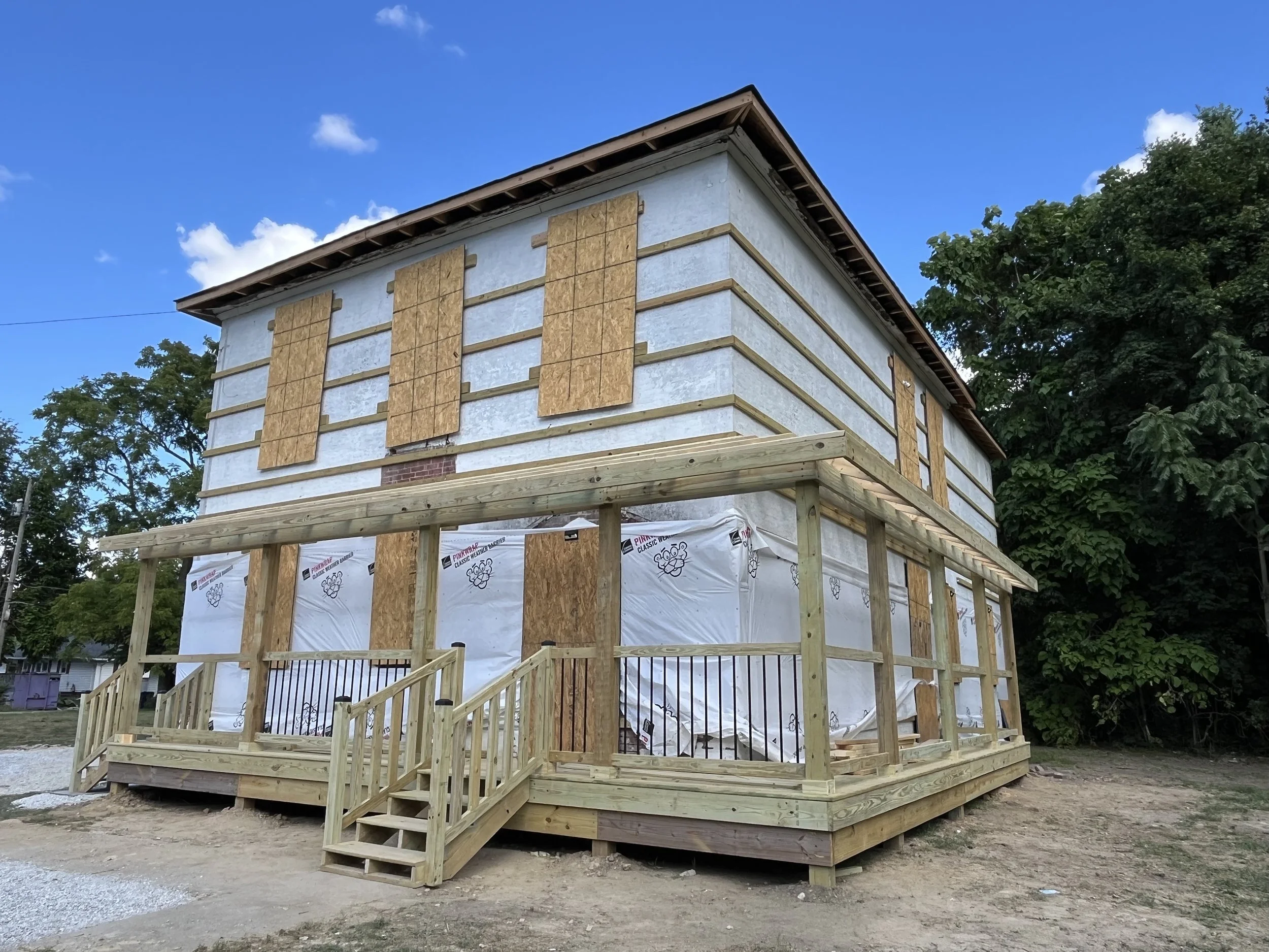 With the porch all buttoned up, we can finish the second floor windows and start in the metal siding. 