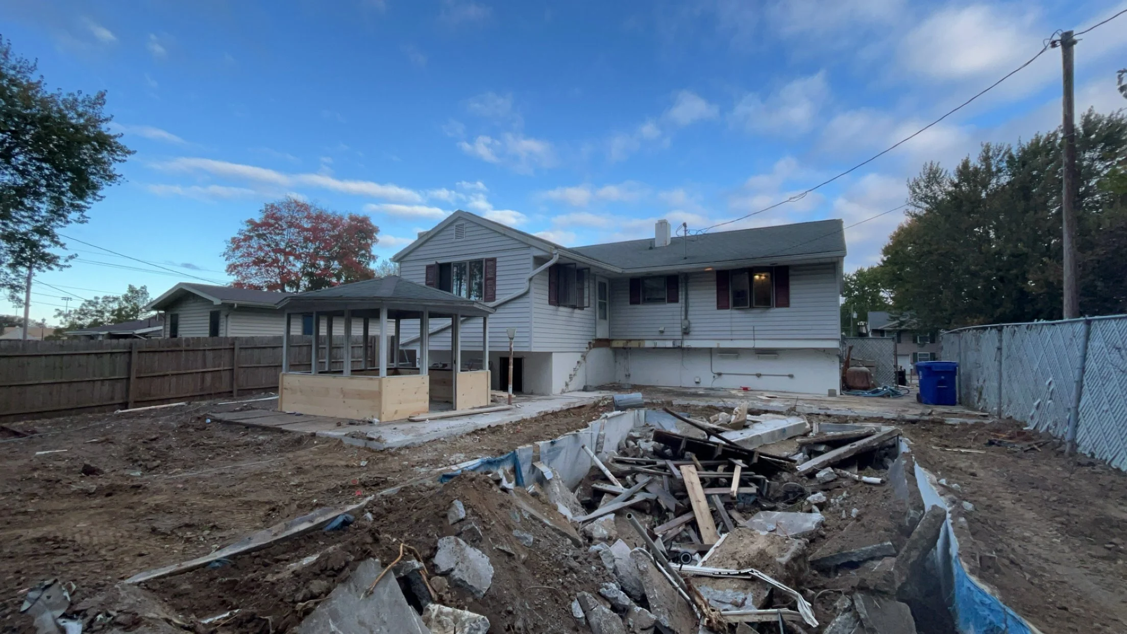 Demo and grading work behind the house.