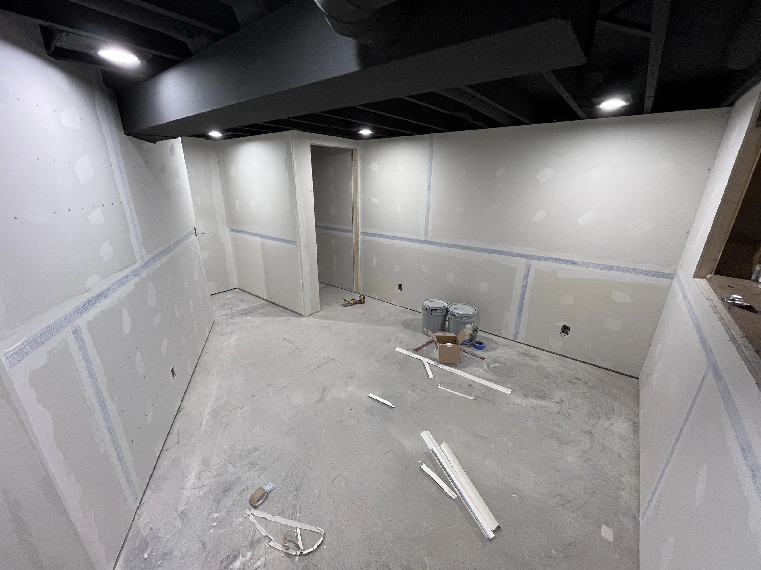 Drywall up! first coat of mud/tape. (Basement bedroom)