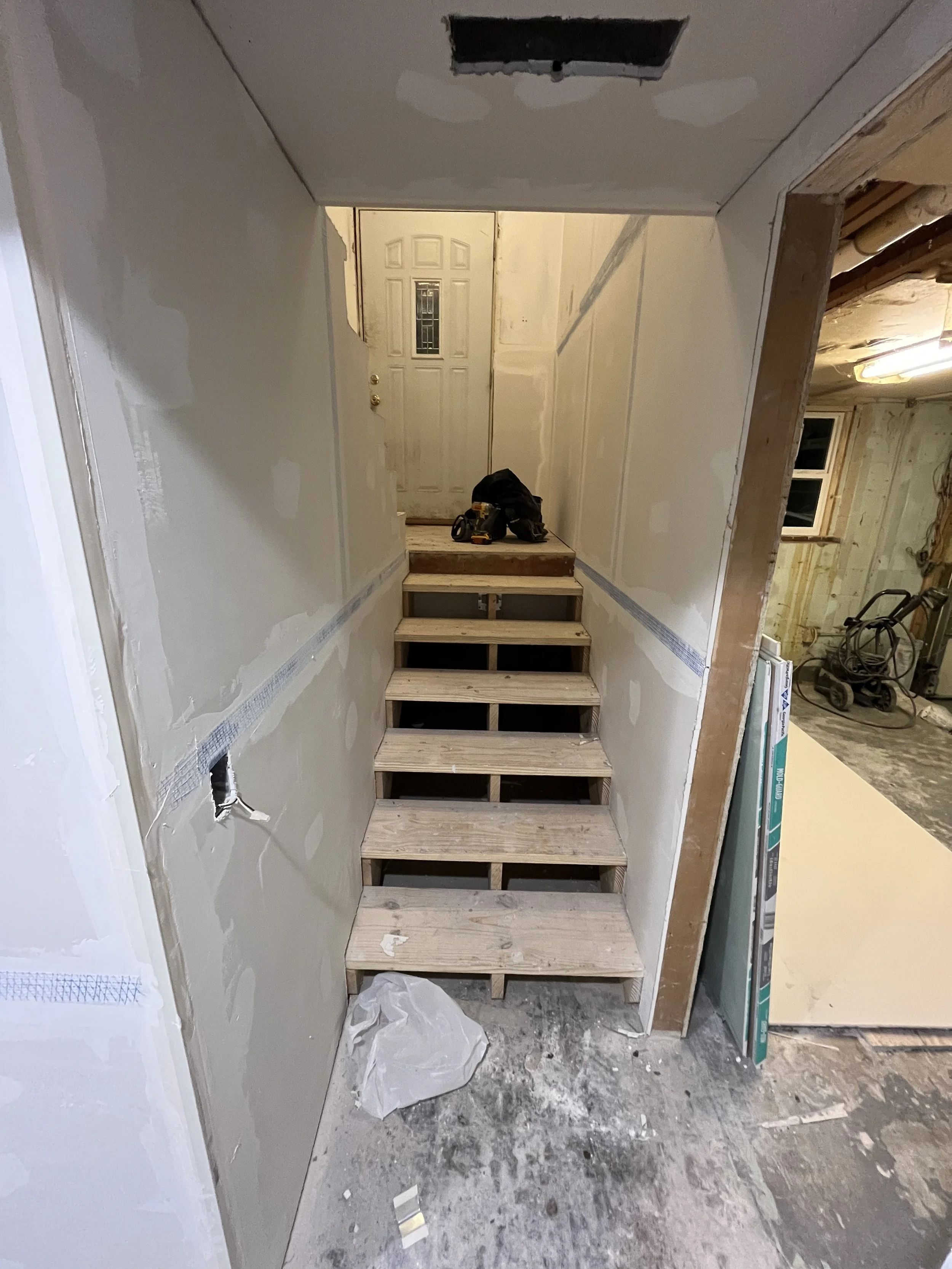 Basement stairs heading up to the landing.