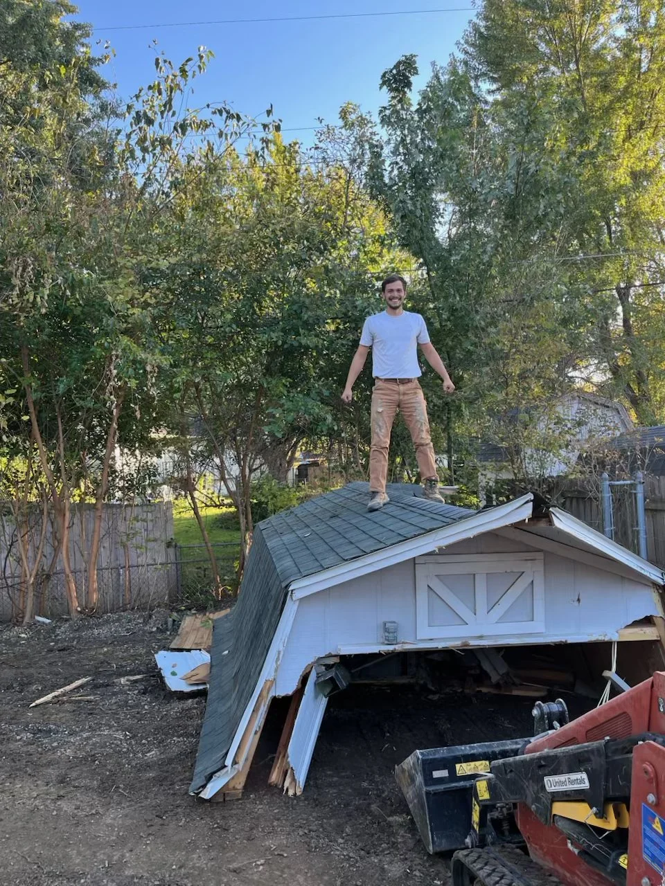 Shane Miller (Co-Founder) standing on demo shed
