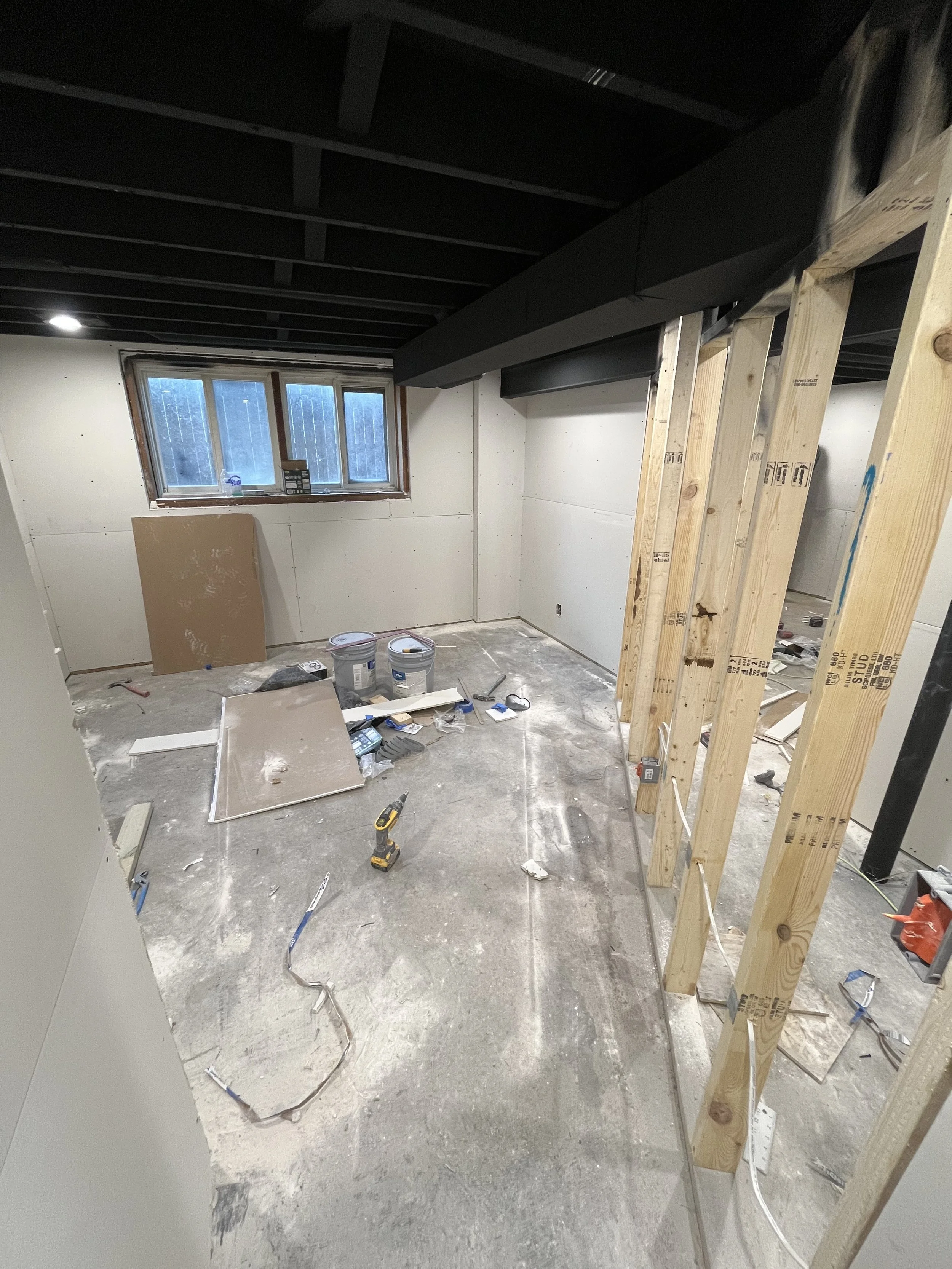 Walls up, ceiling painted black, and dry wall starting to get hung.