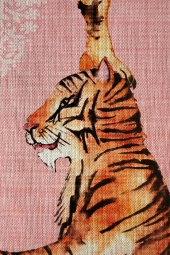 A drawing of a tiger with orange fur and black stripes, set against a pink background.
