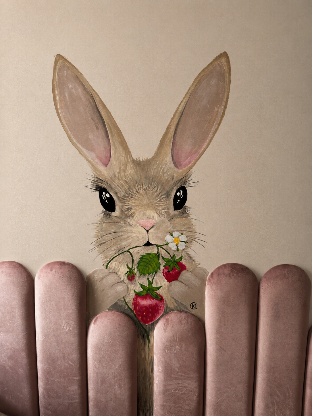 Hand-painted bunny mural holding a strawberry and flower, framed by blush velvet wall panels that I added, creating a playful accent wall for a child’s room.