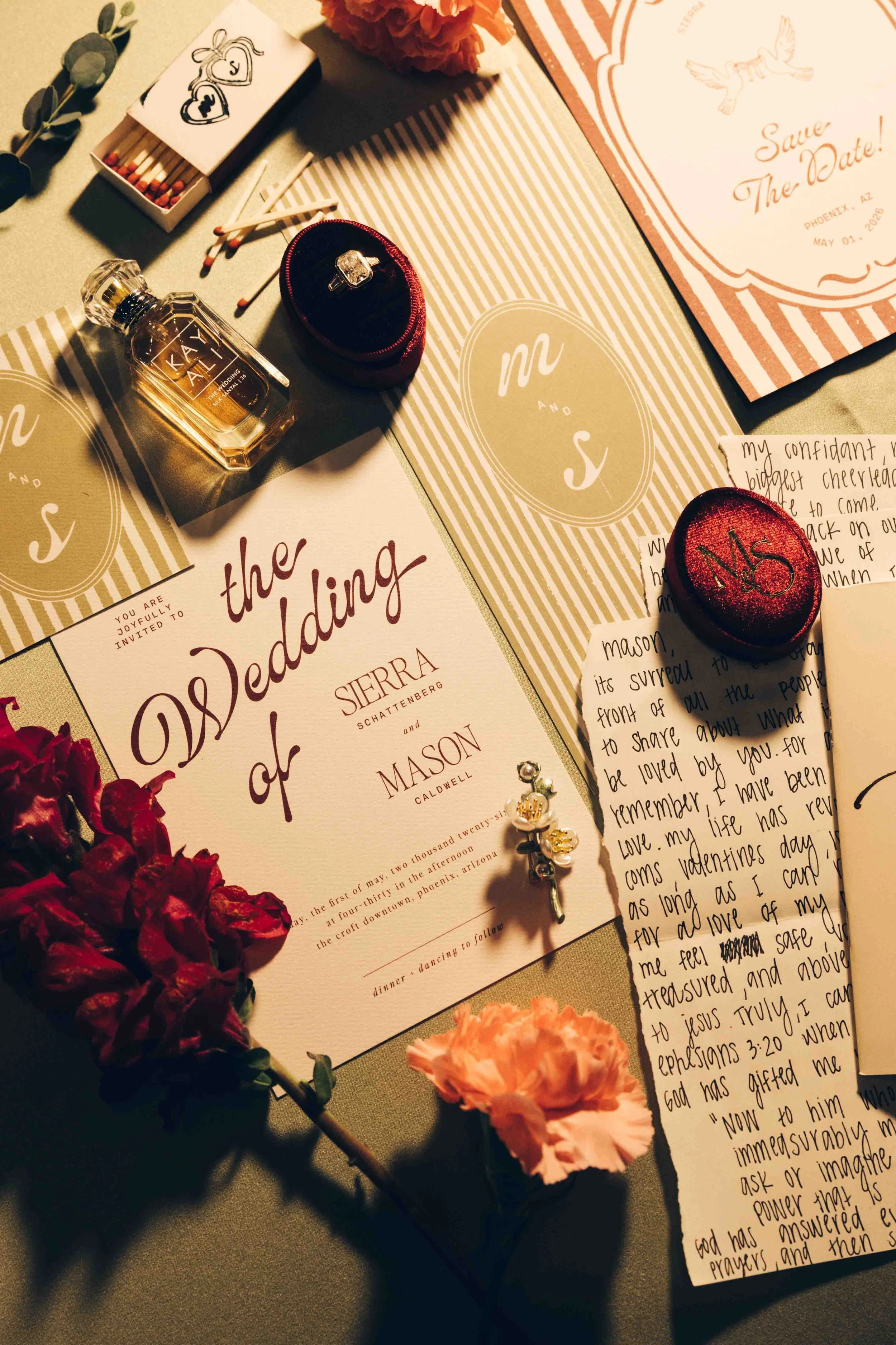 Save the date card for a wedding at Sierra Schattendberg and Mason Caldwell, May 1, 2028, in Phoenix, Arizona. The table has a bottle of Kay Ali perfume, a small open jewelry box with a ring, matches, a handwritten letter, and several decorated cards