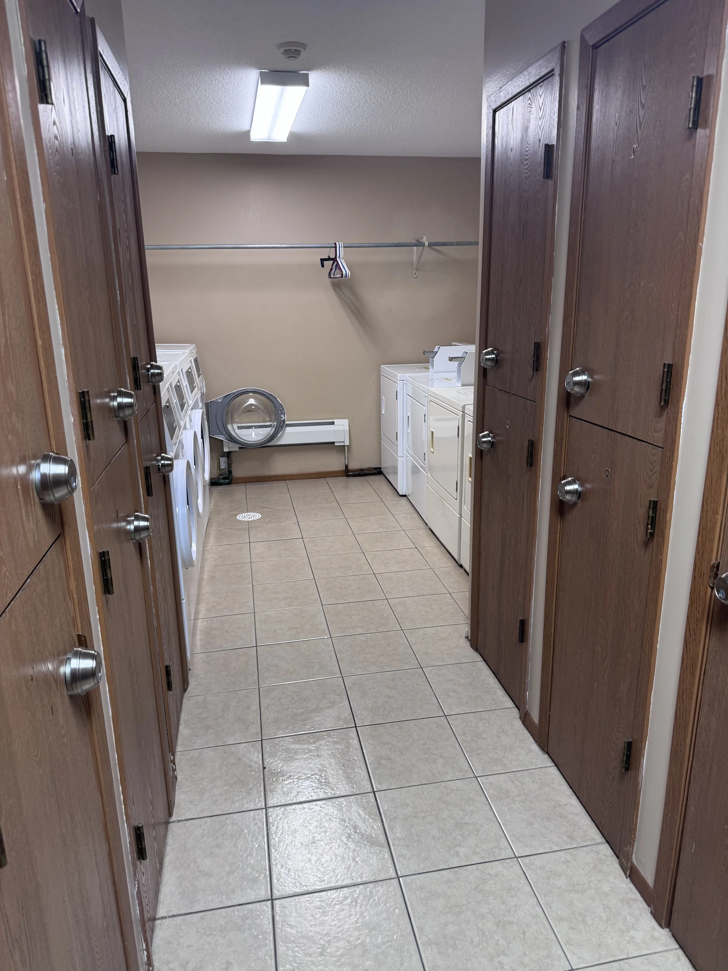Clean shared laundry room hallway maintained by Fuentes Service Providers
