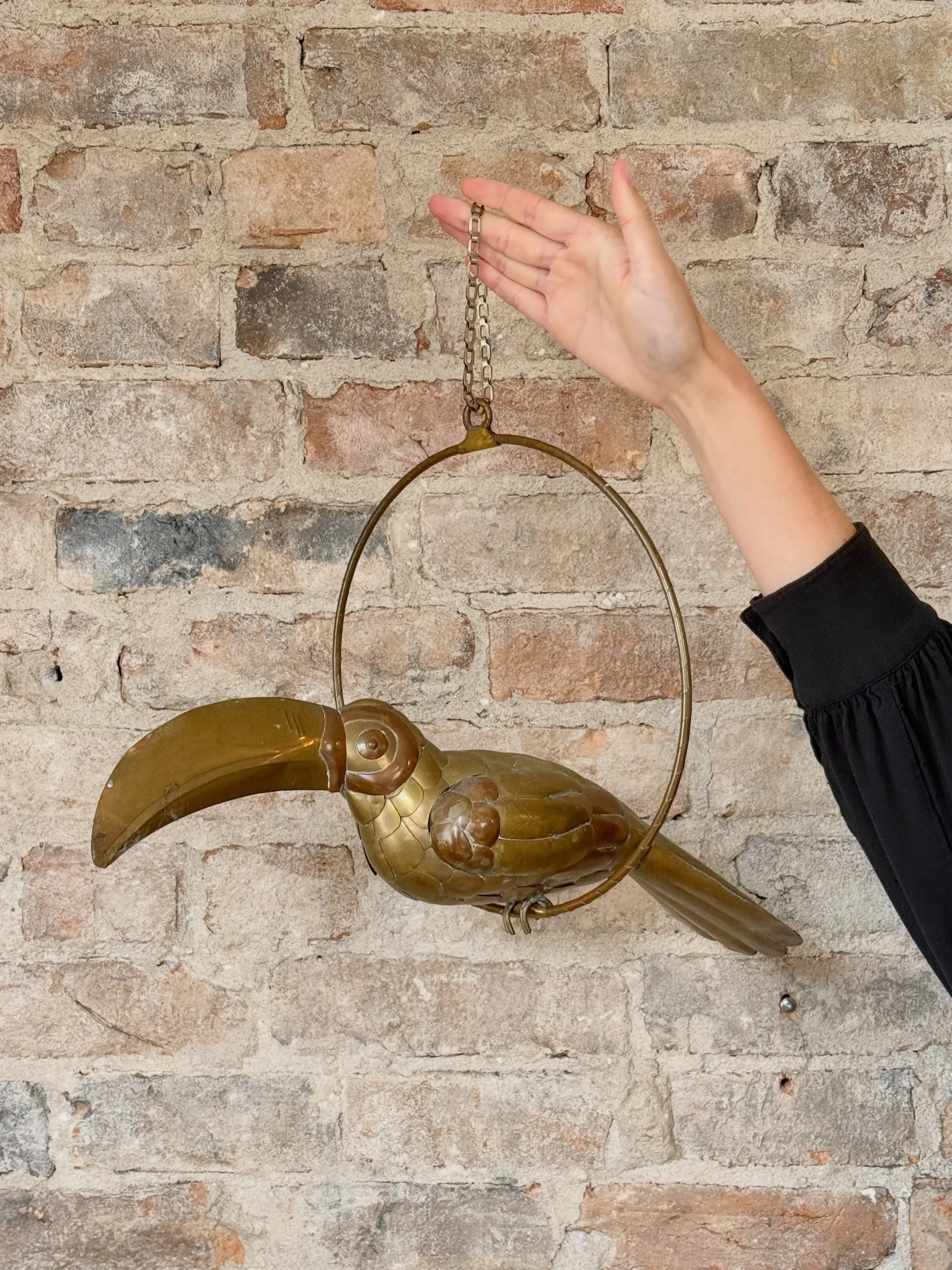 object of the day 🤯

incredible brass and copper hanging toucan sculpture in the style of Sergio Bustamante. delicately hand-crafted and perched upon the original hanging hoop. 

very jealous of whoever takes this bad boy home. thanks @designmaze_ti