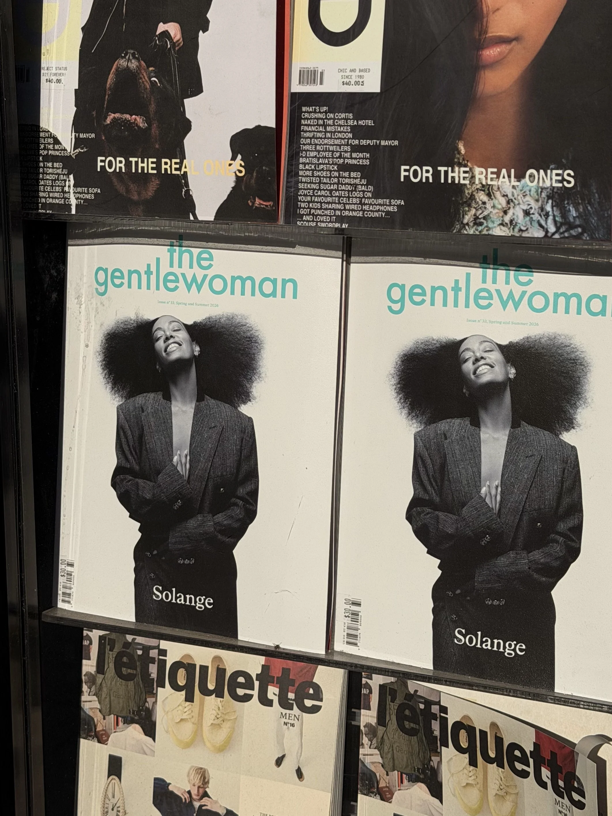 Magazine covers with the words 'FOR THE REAL ONES' and 'the gentlewoman'. The covers feature black and white photos of women and a woman with curly hair.