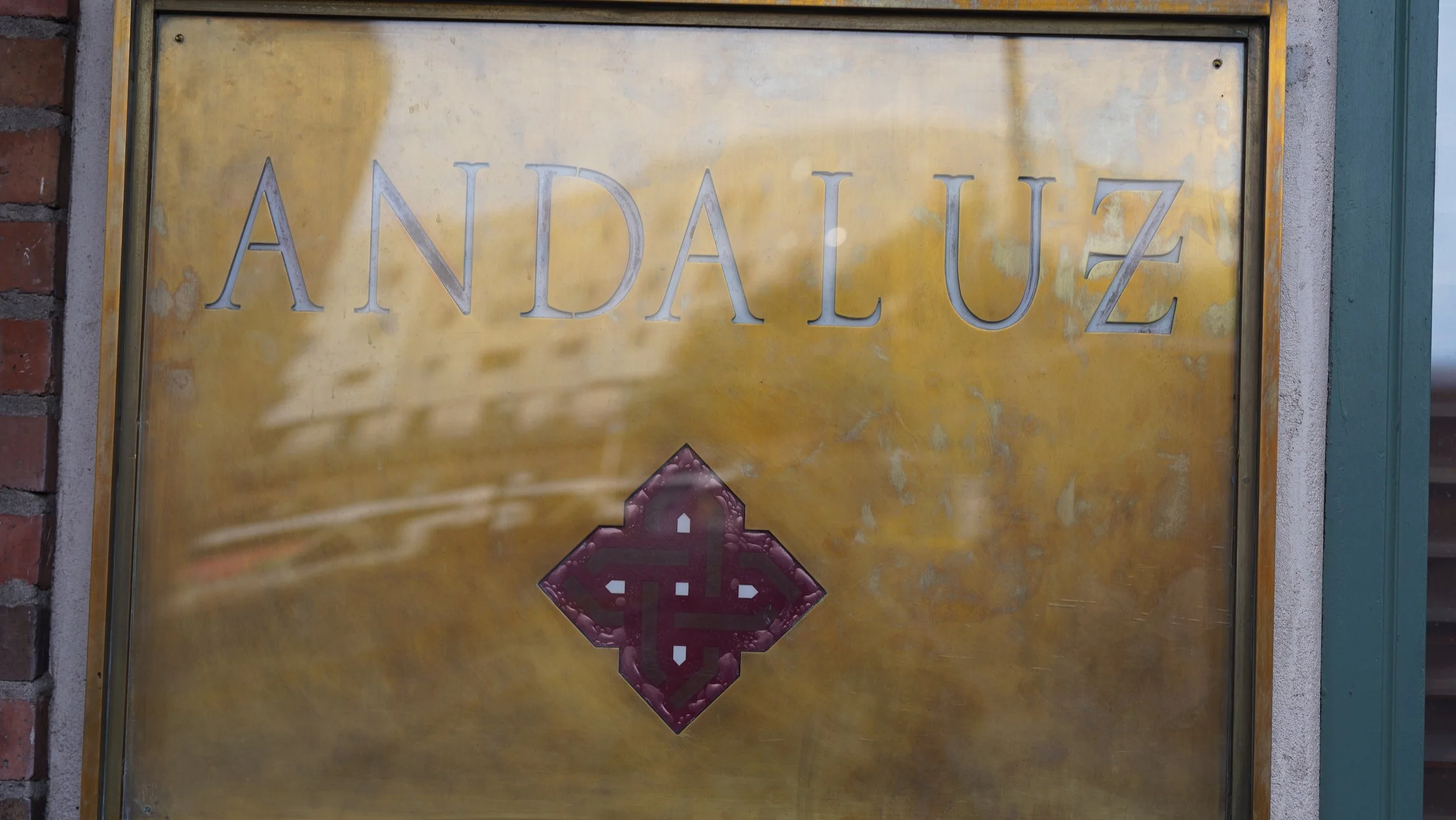 A brass plaque with the name 'ANDALUZ' engraved on it.