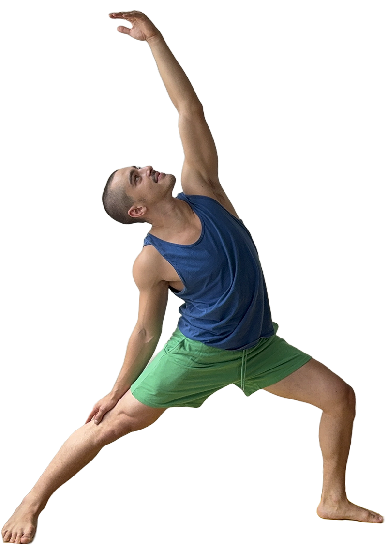 A man practicing yoga indoors, in a wide lunge pose with one arm raised overhead and the other hand on his knee, on a yellow yoga mat.