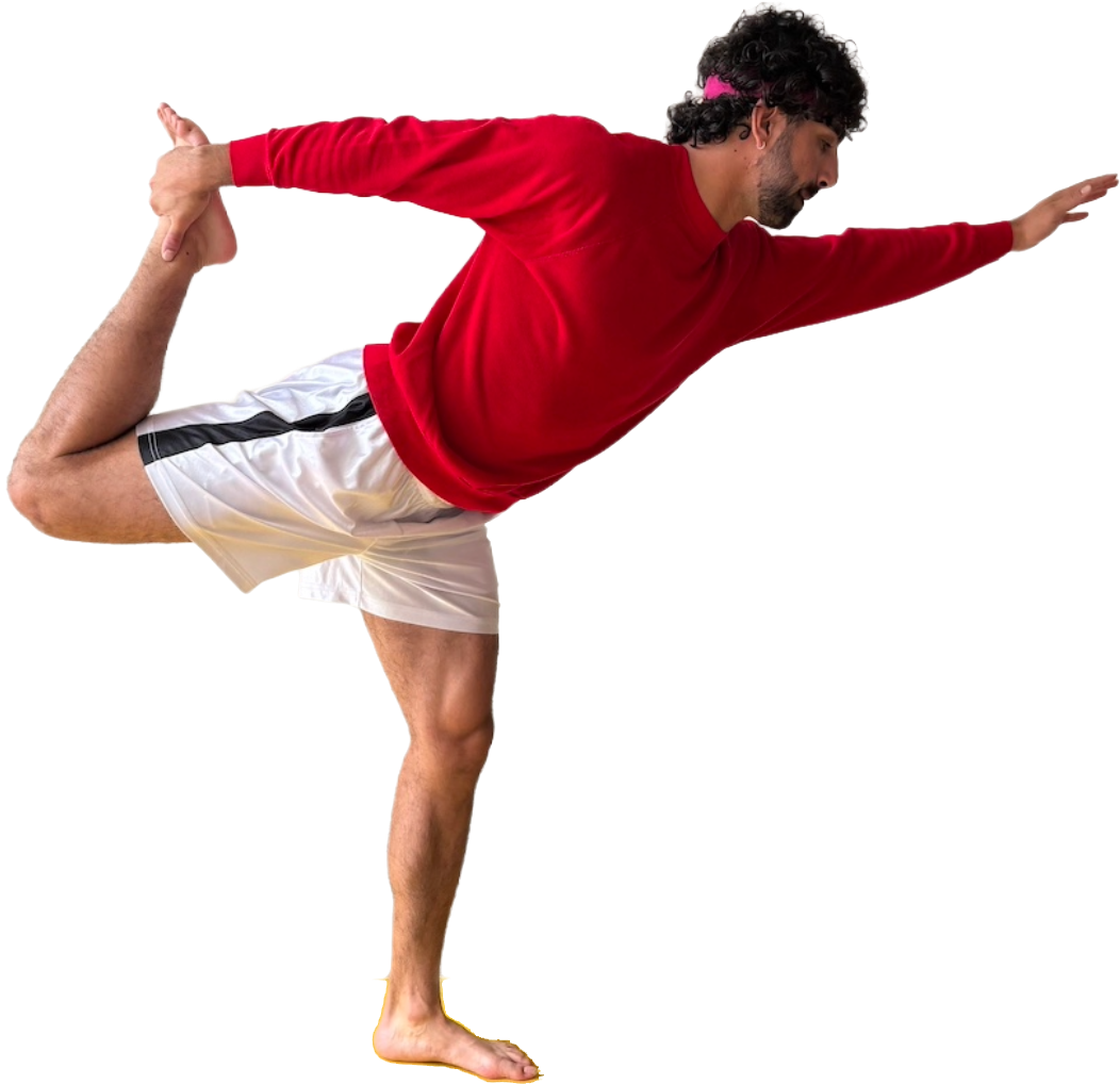 A man in a red long-sleeve shirt and white shorts is performing a yoga pose, balancing on one leg while holding the other foot behind his back with one hand and extending the other arm forward.