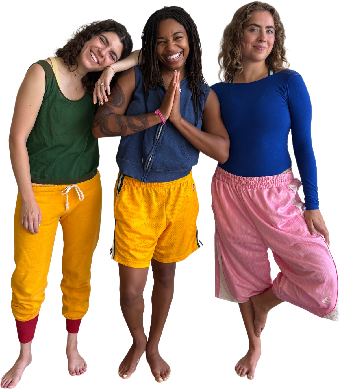 Three women standing closely together, smiling and posing for a photo with arms around each other, dressed in colorful athletic clothing.