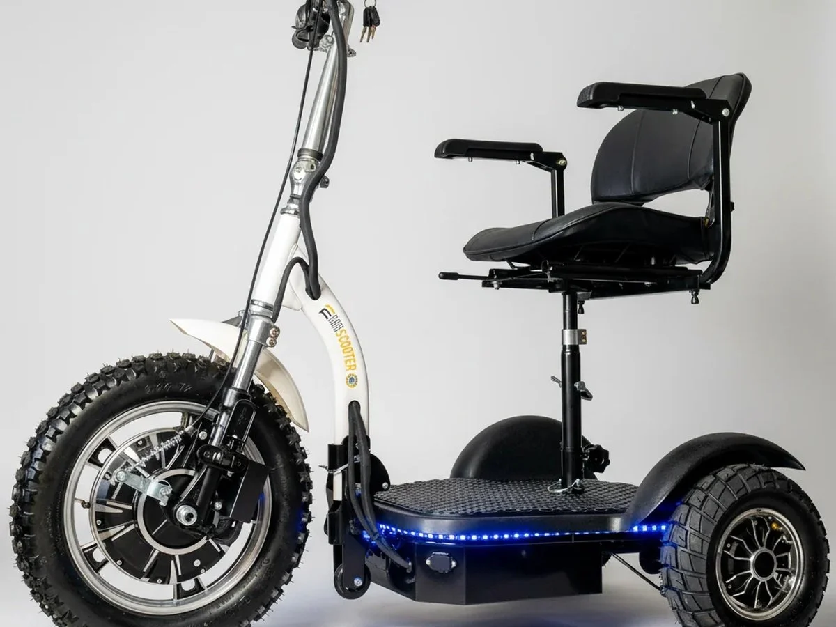 Electric scooter with large off-road tires, black seat, and LED lights on the base, against a plain white background.