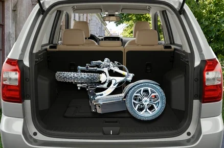 A robotic wheelchair inside the trunk of a silver SUV