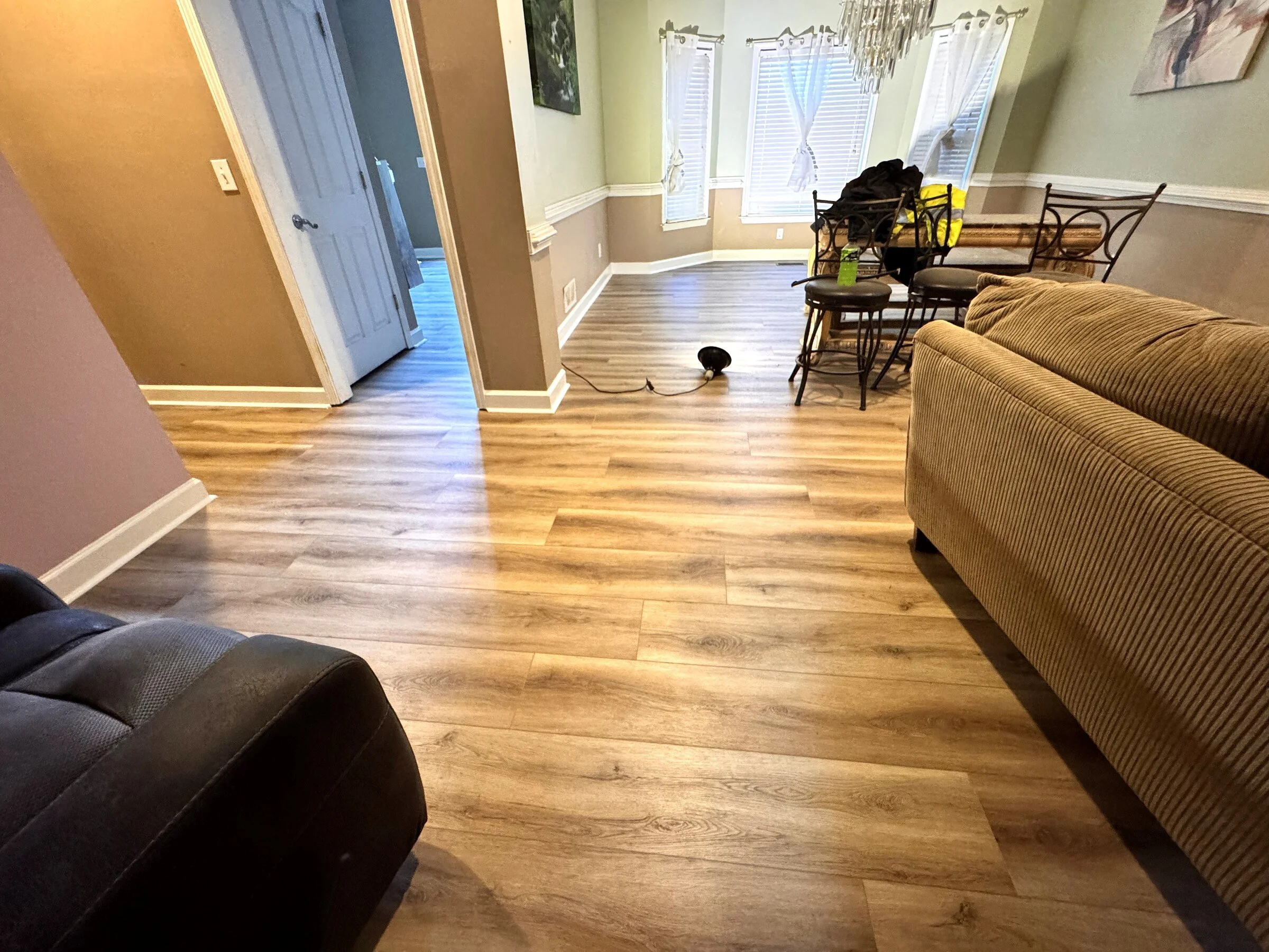 Completed luxury vinyl plank flooring in an open Atlanta-area living room