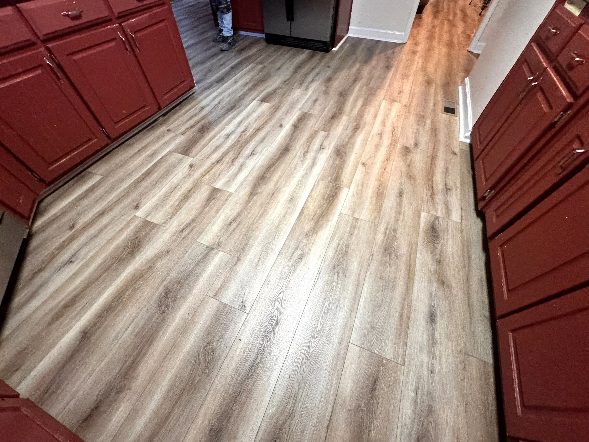 Completed luxury vinyl plank flooring installation in an Atlanta-area kitchen