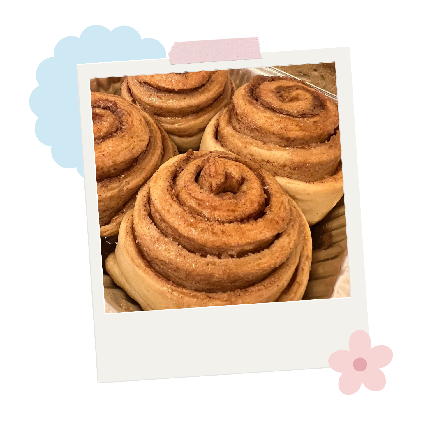 Freshly baked cinnamon rolls topped with icing in a basket.