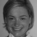 Black and white portrait of a smiling young woman with short hair
