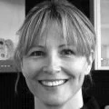 Portrait of a woman with short blonde hair smiling